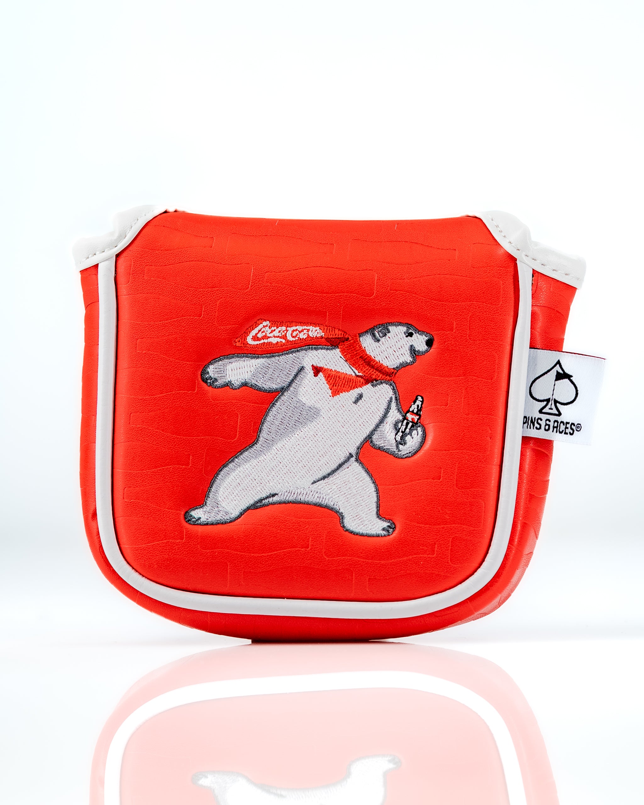 Coca-Cola mallet putter cover featuring a playful polar bear design on a vibrant red background.