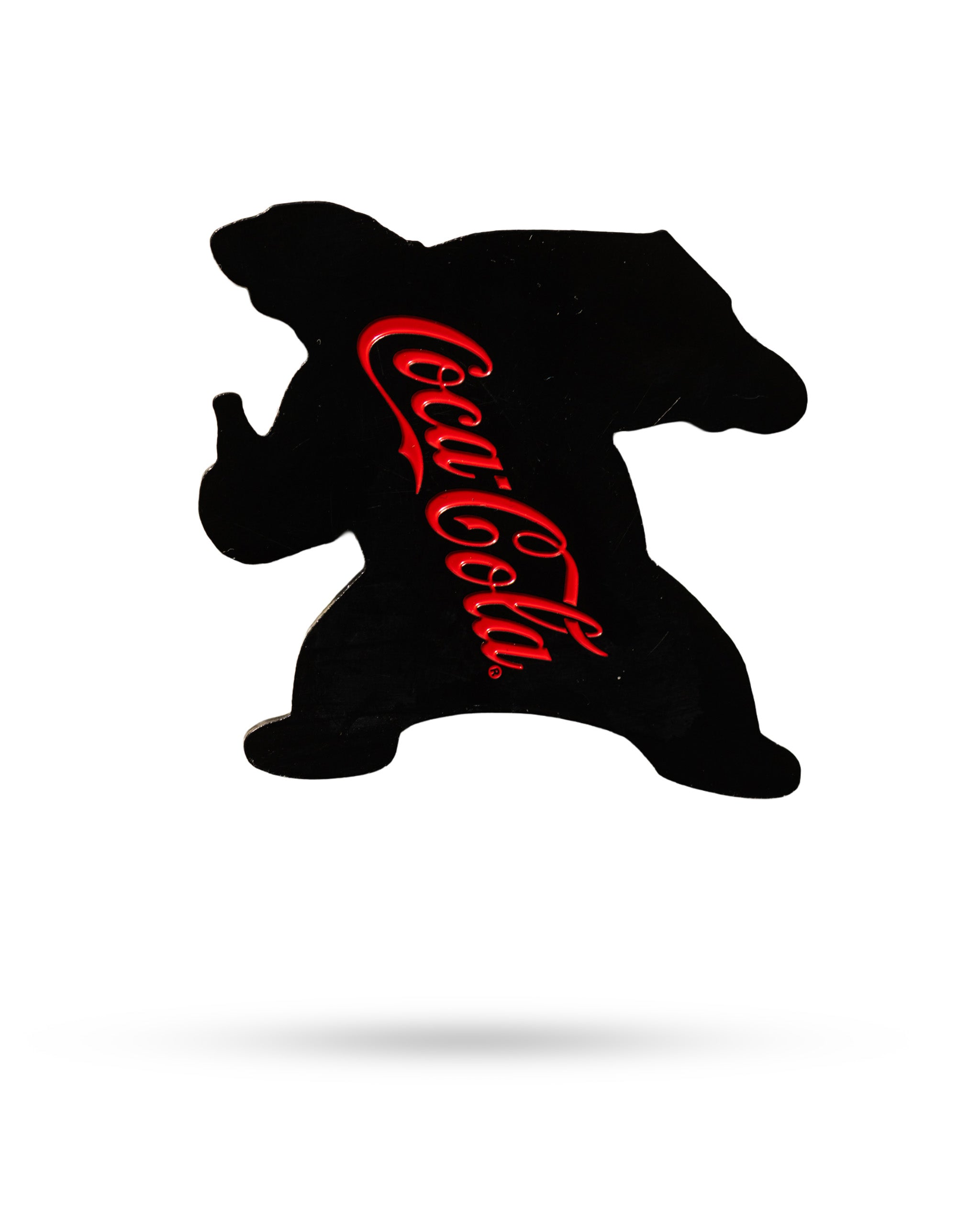Coca-Cola Bear ball marker featuring a silhouette of the bear with the Coca-Cola logo in red. Ideal for golf enthusiasts.