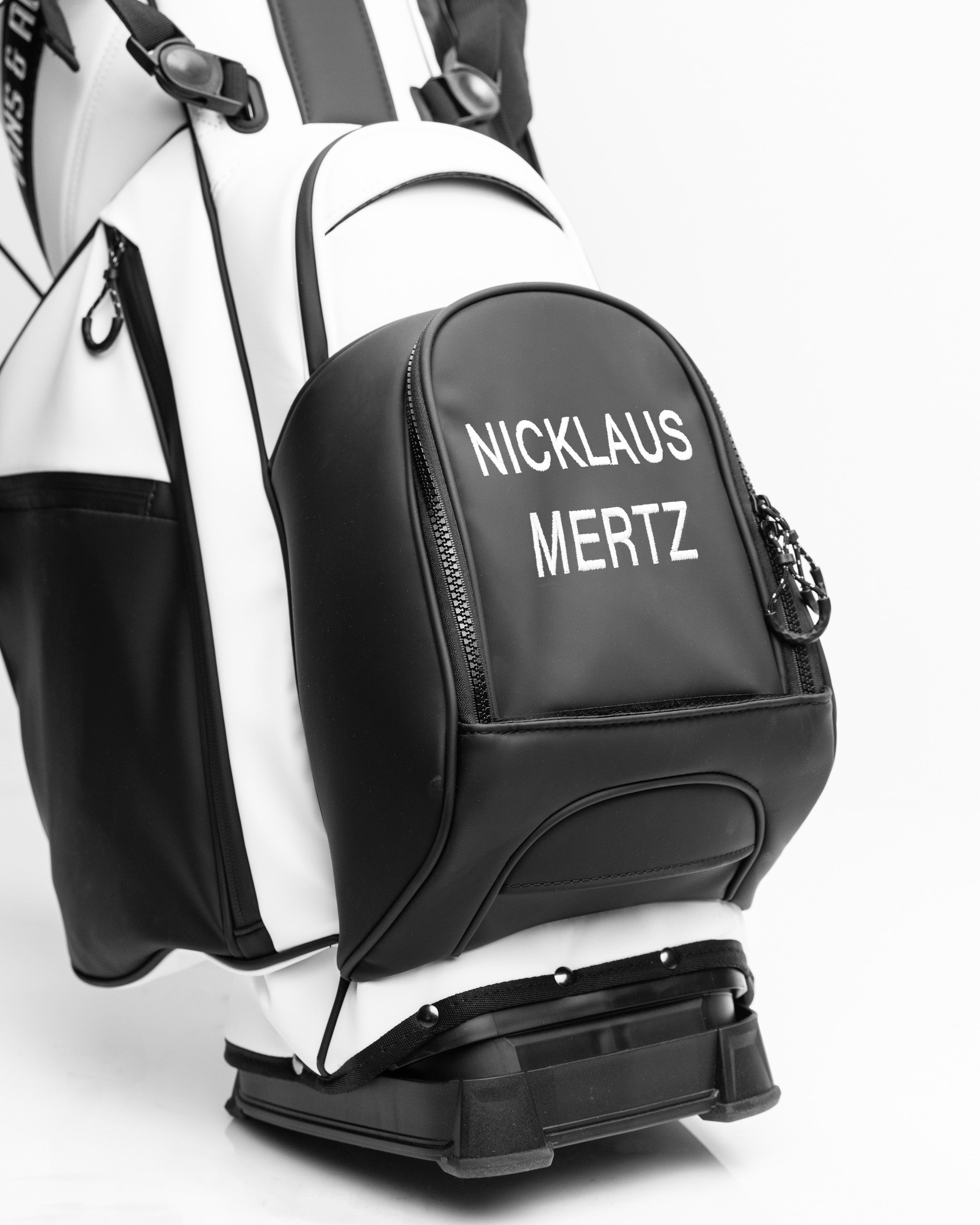 Personalized bag pocket featuring custom name embroidery on a stylish fabric background.