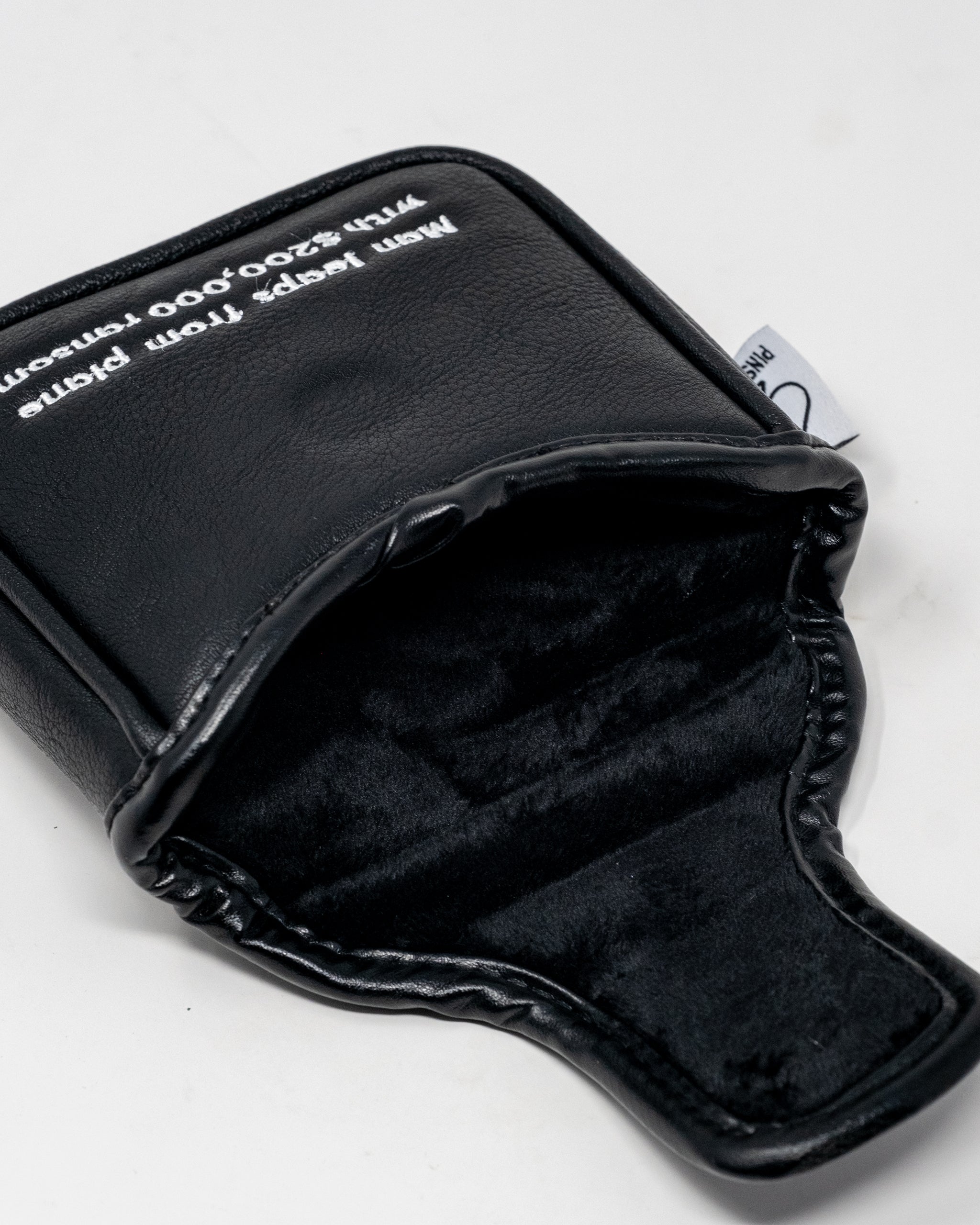 D.B. Cooper mallet putter cover featuring a sleek black design with white accents and unique graphics.