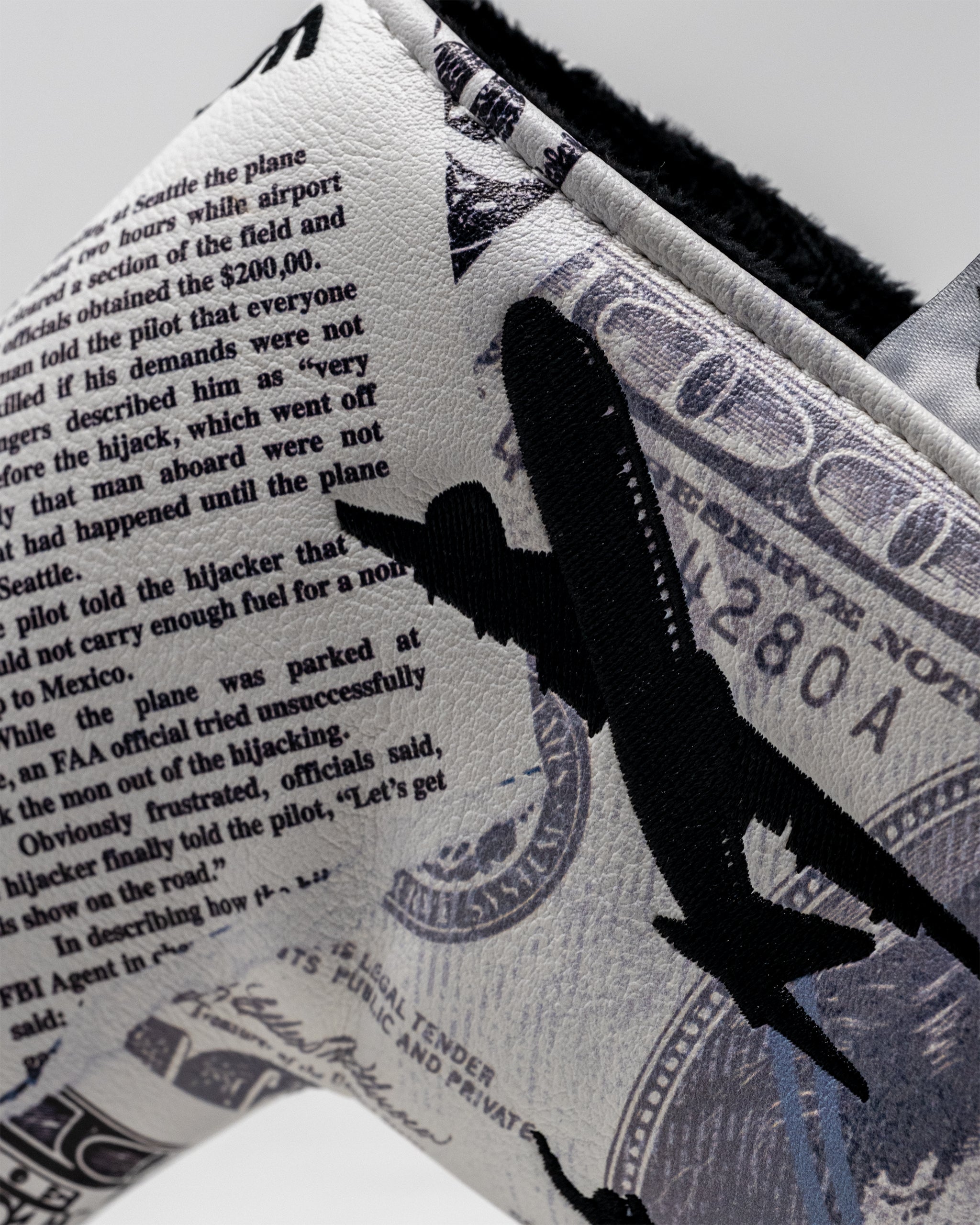 D.B. Cooper Blade Putter Cover in black with white accents and bold lettering, featuring a unique design for golf enthusiasts.