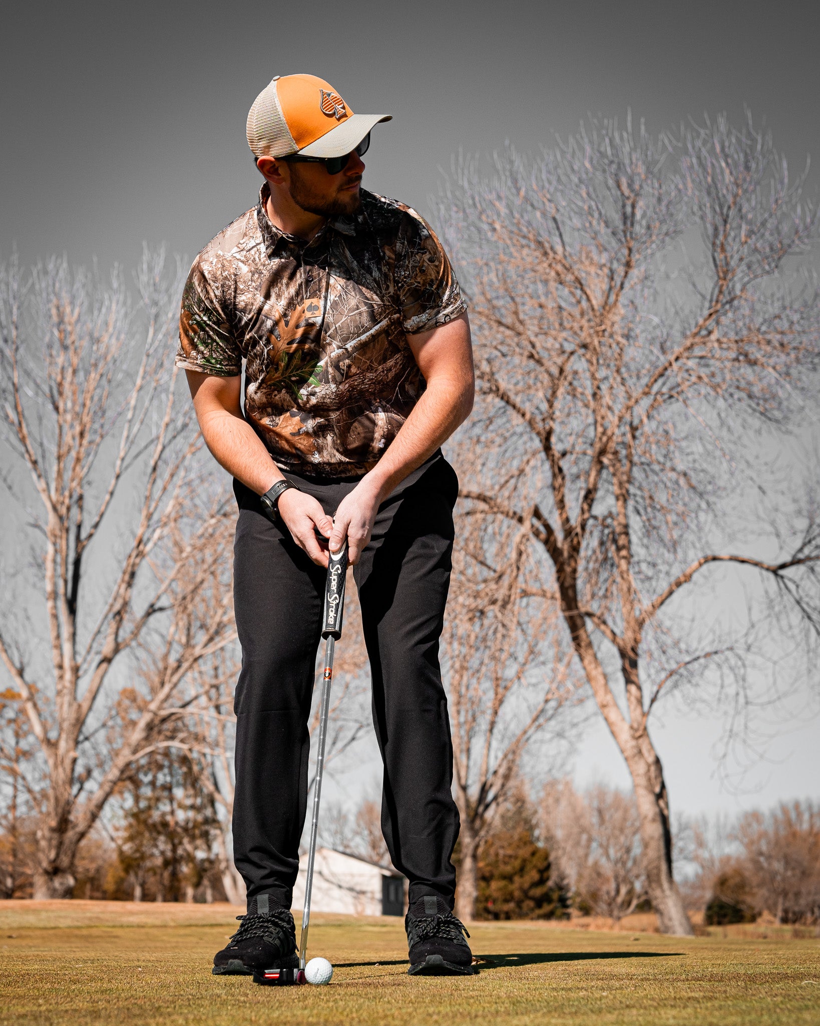 Realtree Edge Polo, featuring a camouflage pattern with a classic collar and short sleeves, displayed on a neutral background.