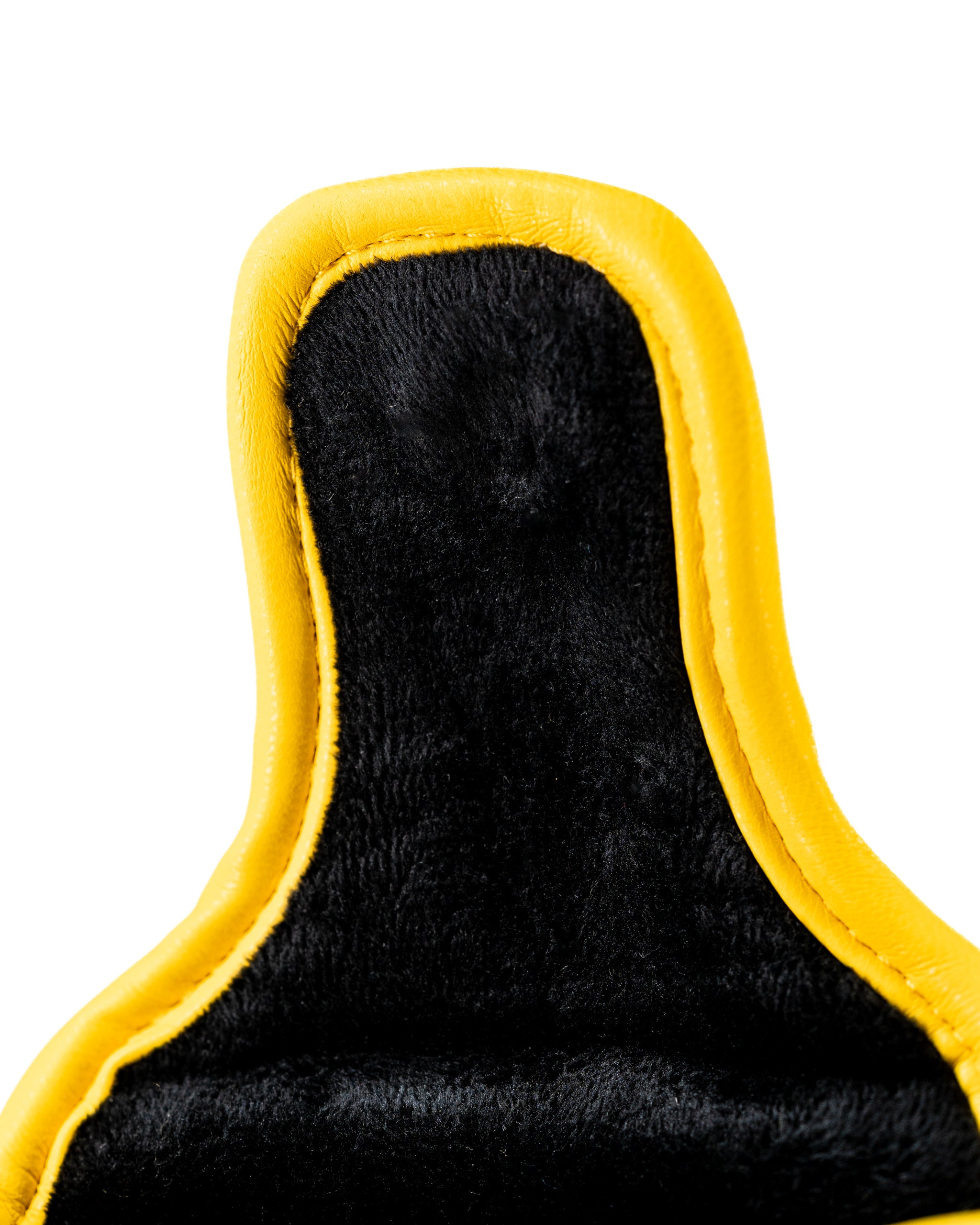 Close-up of the top of a black mallet putter cover with a yellow trim, featuring a soft, plush interior for protection.