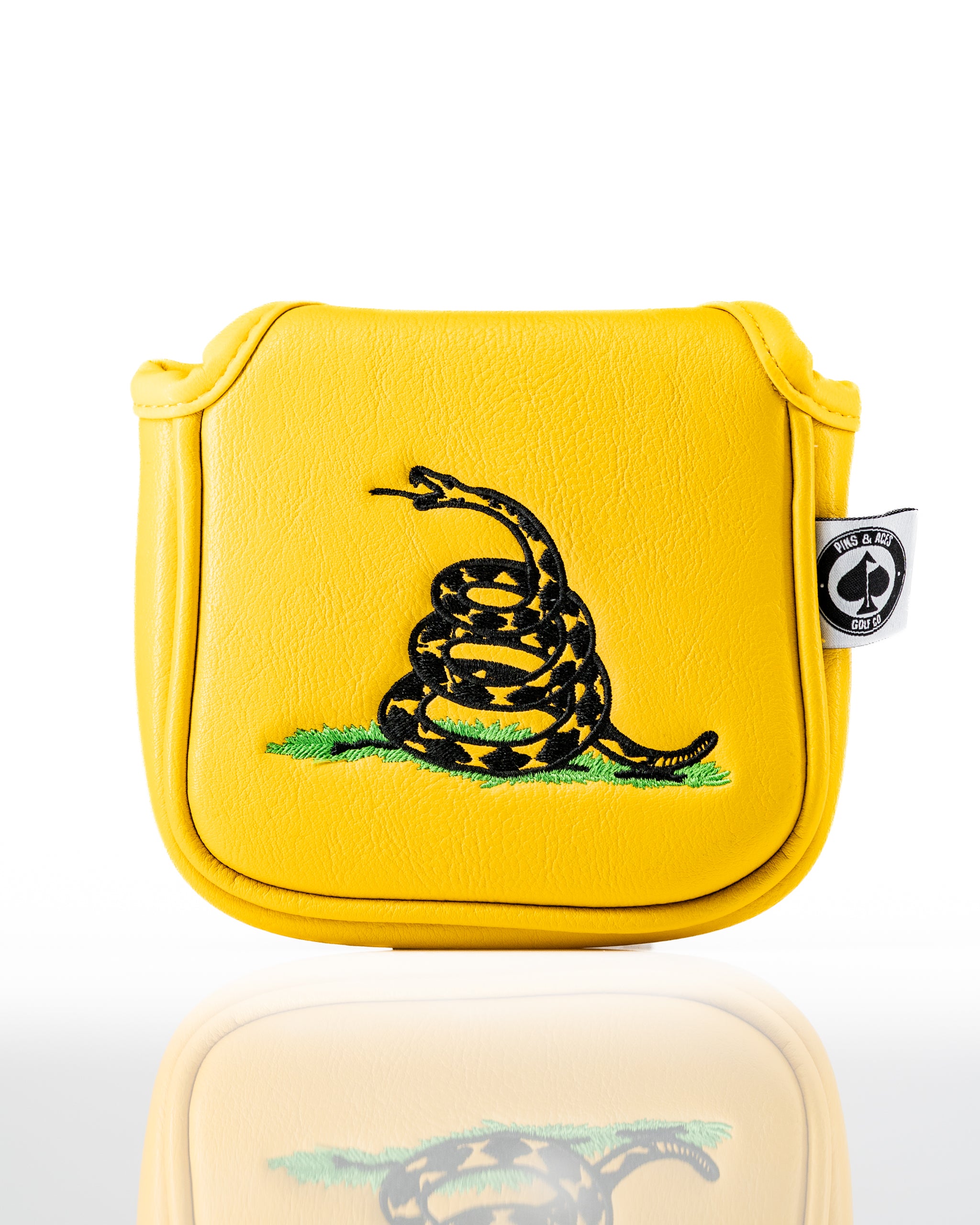 Bold yellow mallet putter cover featuring a black snake design and "Don't Tread on Me" emblem for standout golf style.