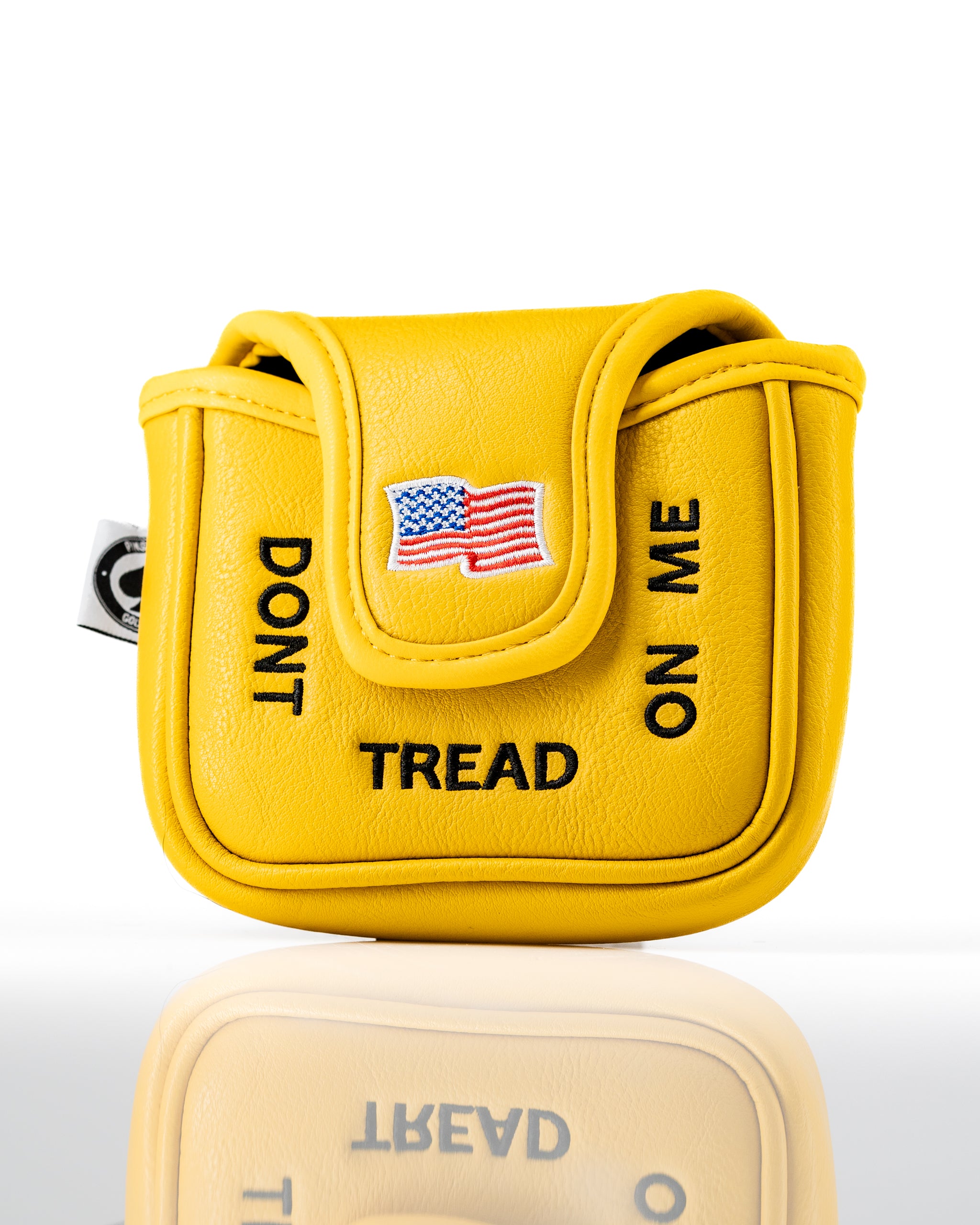 Bright yellow mallet putter cover featuring "Don't Tread on Me" text and an American flag emblem for bold golf style.