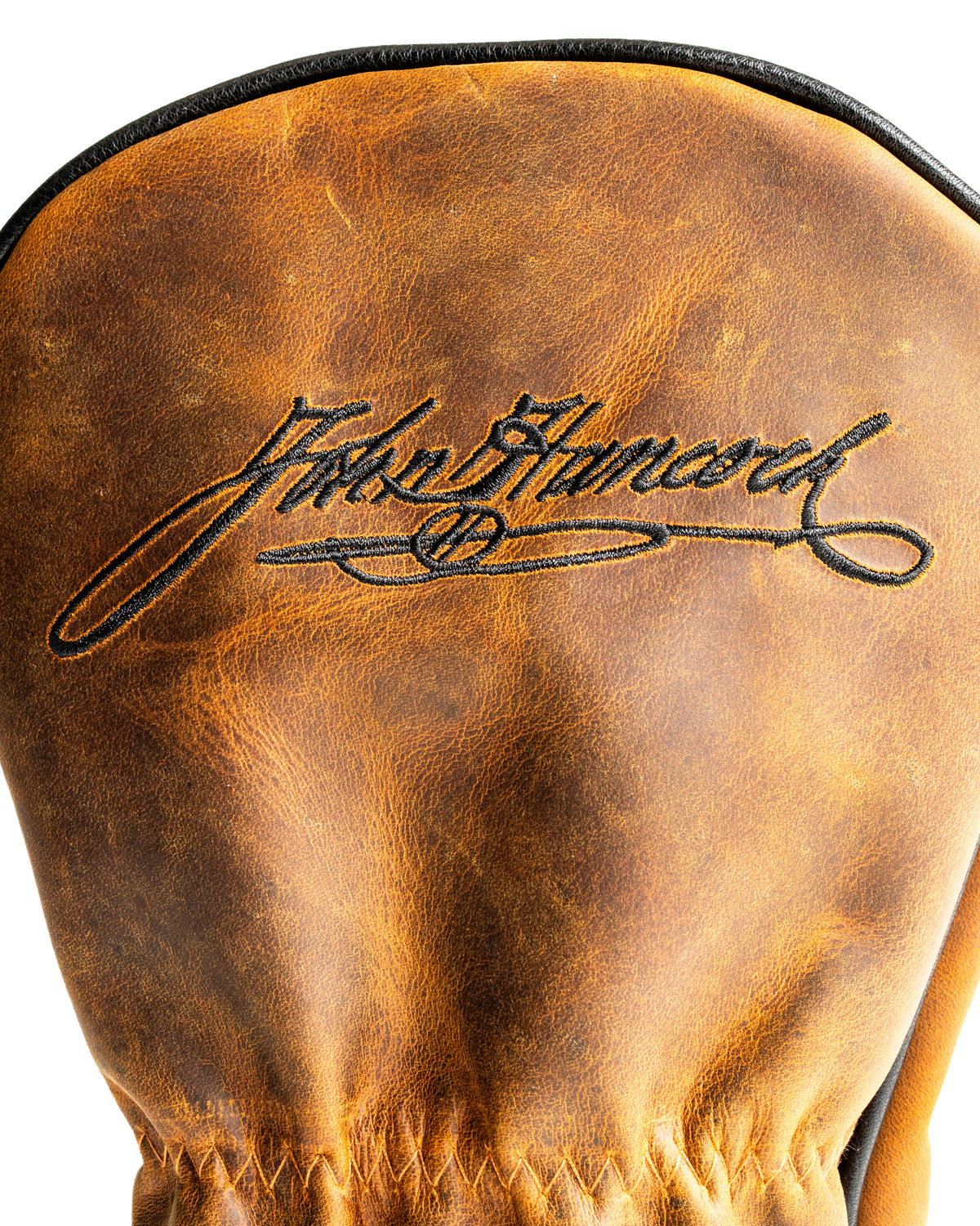 Stylish leather driver cover featuring a signature design, perfect for golfers seeking a bold accessory on the course.