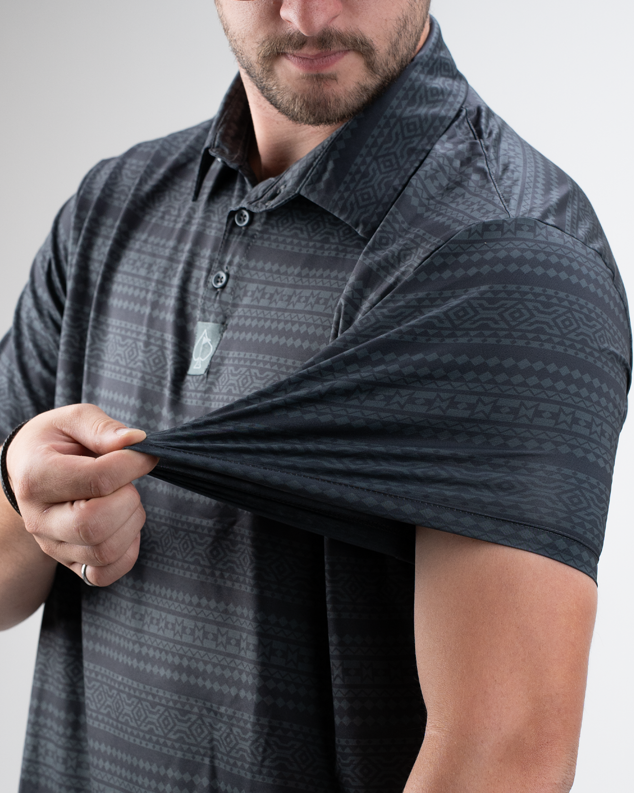 Model showcasing the Desert Geo golf polo shirt, highlighting its unique geometric pattern and comfortable fit.