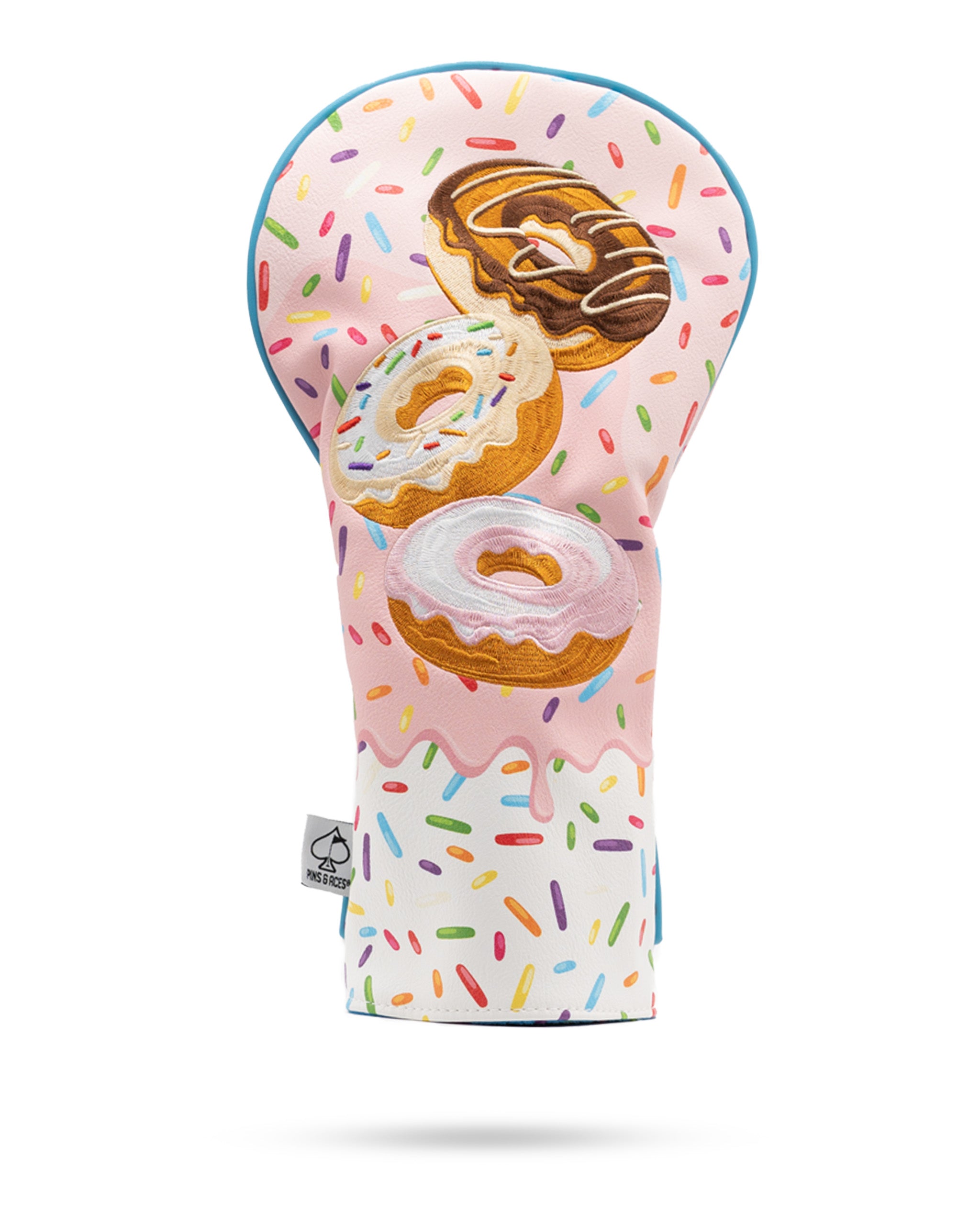 Colorful driver cover featuring a playful design of donuts with sprinkles on a pink background, perfect for unique golf style.