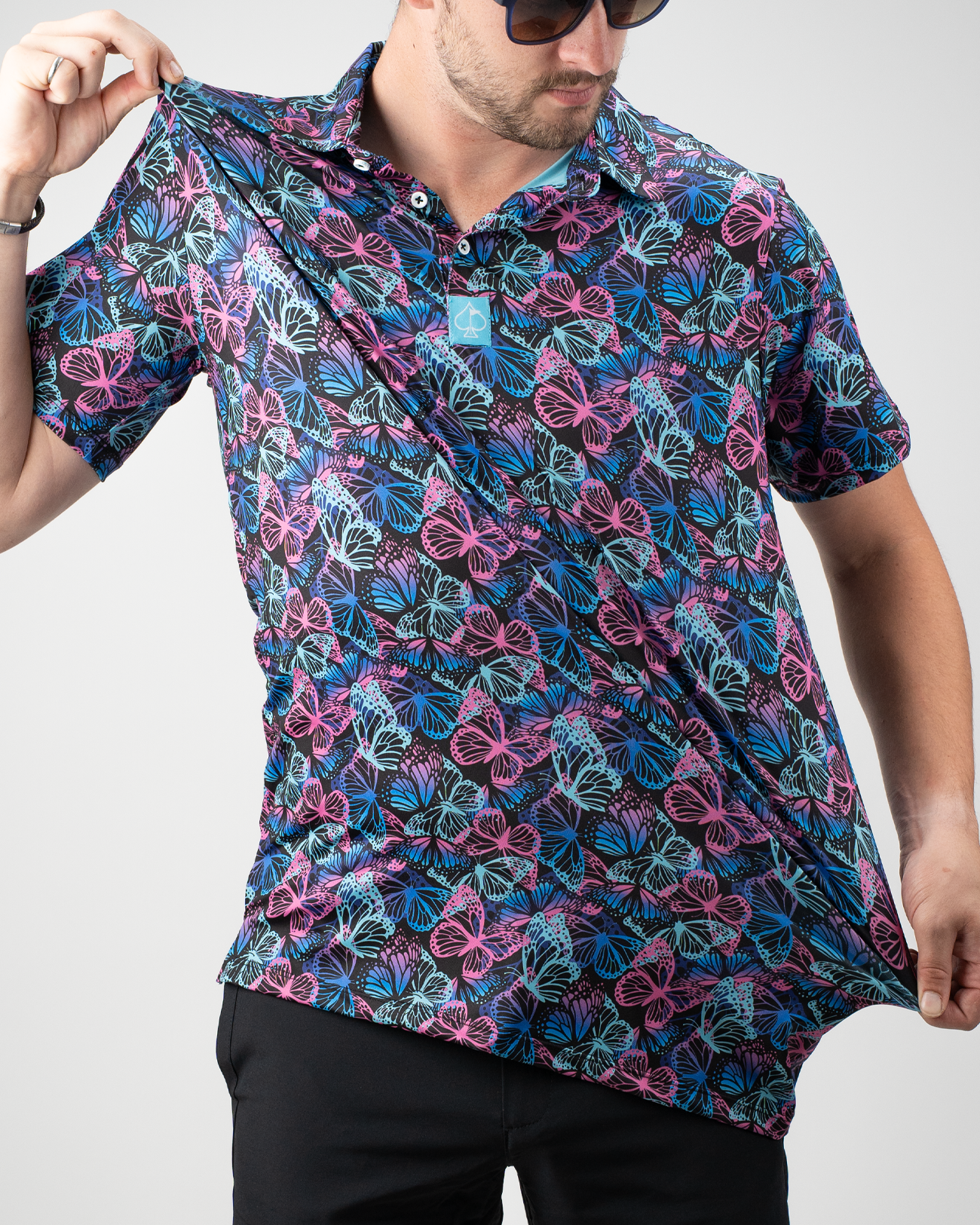 Men's electric butterfly polo shirt featuring a vibrant butterfly print in blue and pink, perfect for stylish golfers.