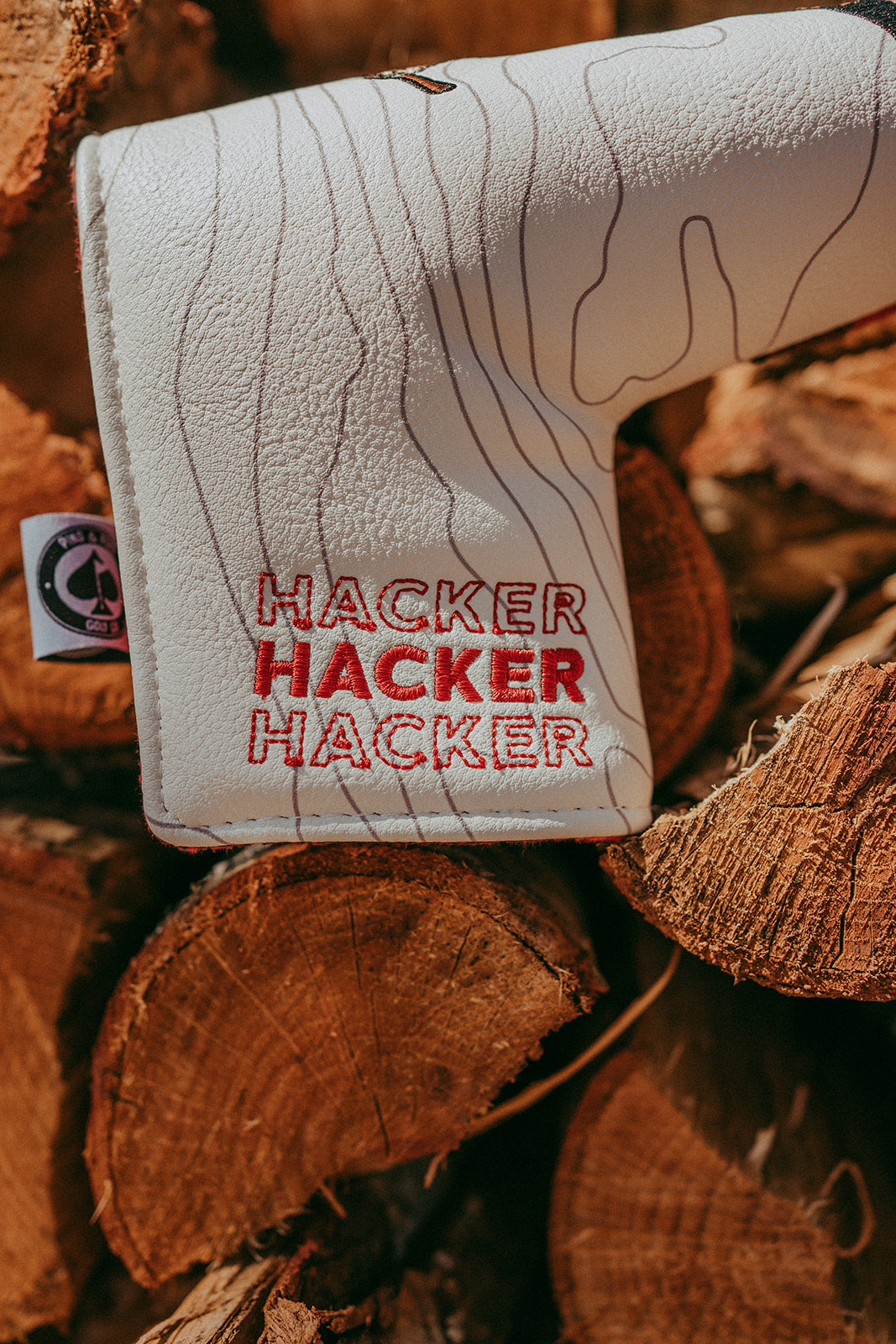Hacker Blade Putter Cover in black with stylized graphics, designed to protect golf putters.