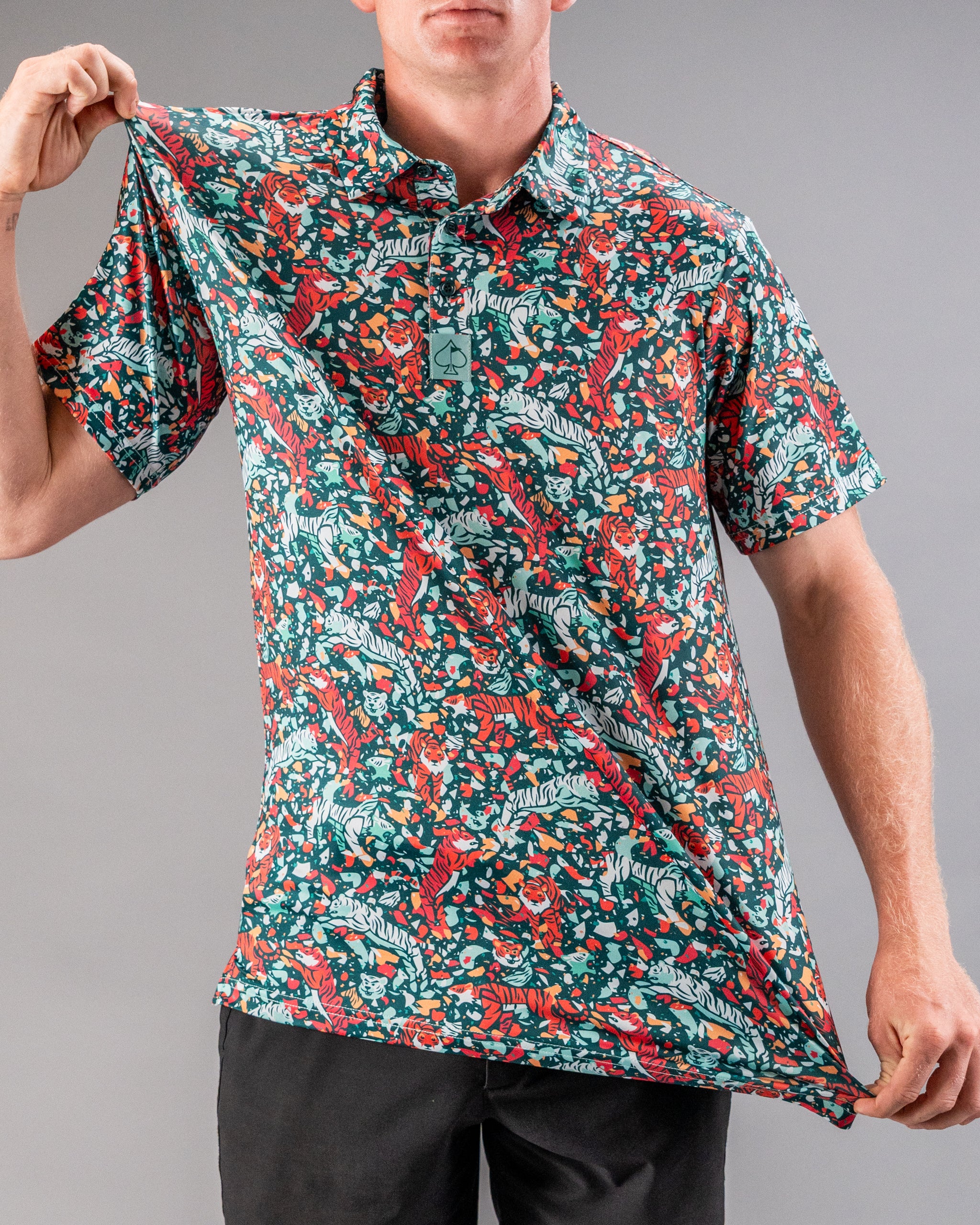 Bold teal golf polo featuring a vibrant tiger and floral pattern, perfect for golfers wanting to stand out on the course.