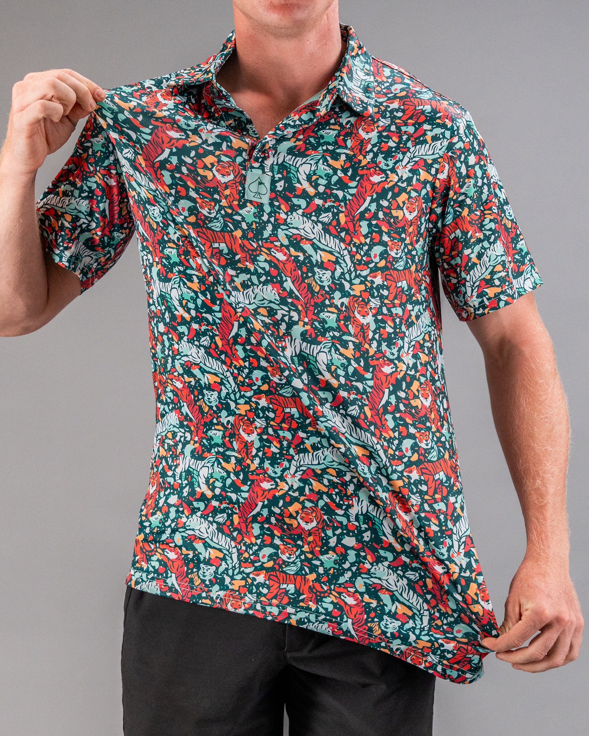 Bold teal golf polo featuring a vibrant tiger and floral pattern, perfect for golfers looking to stand out on the course.
