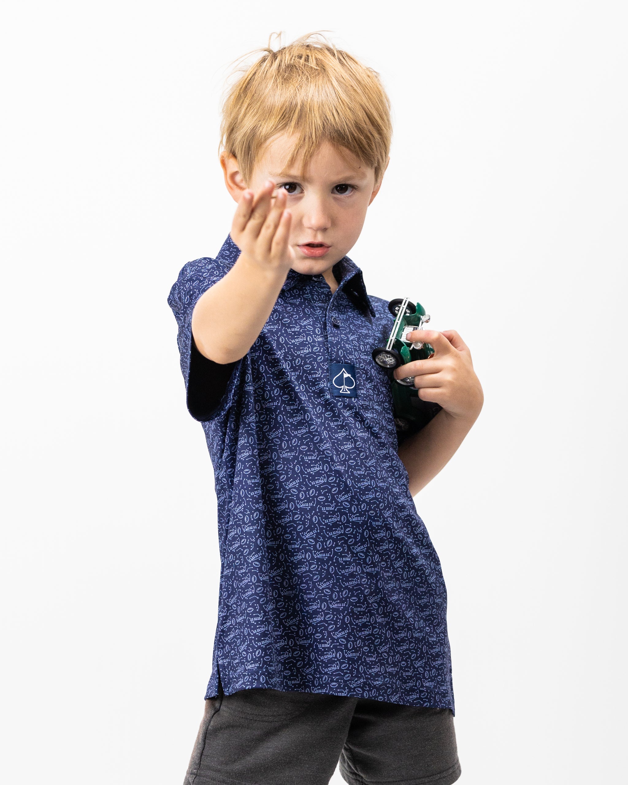 Youth Playmaker polo shirt in vibrant blue with a classic collar and short sleeves, featuring a subtle texture and logo embroidery on the chest.