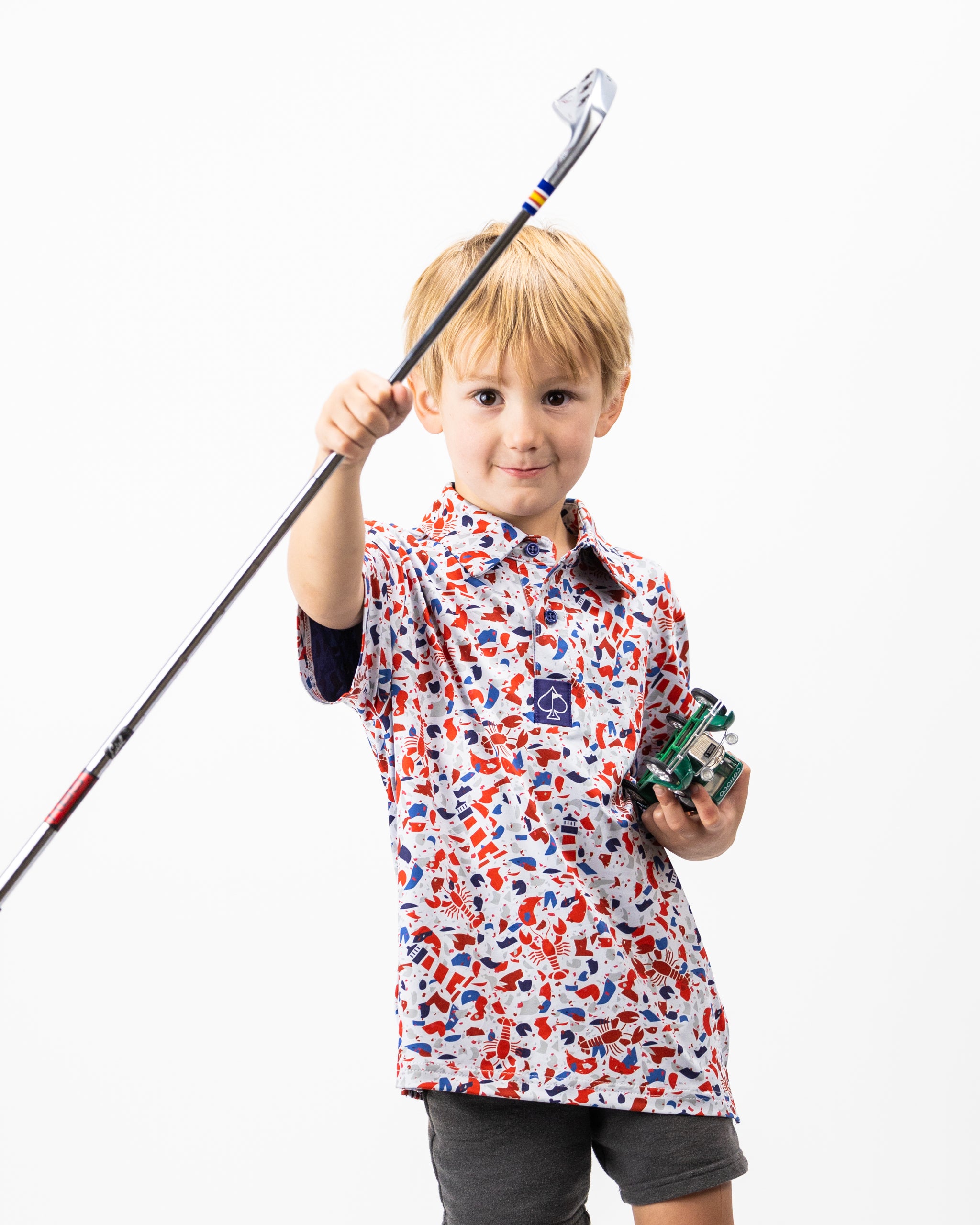 Youth Lobster Shatter lightweight polo shirt in vibrant red with a playful lobster print, perfect for casual wear.
