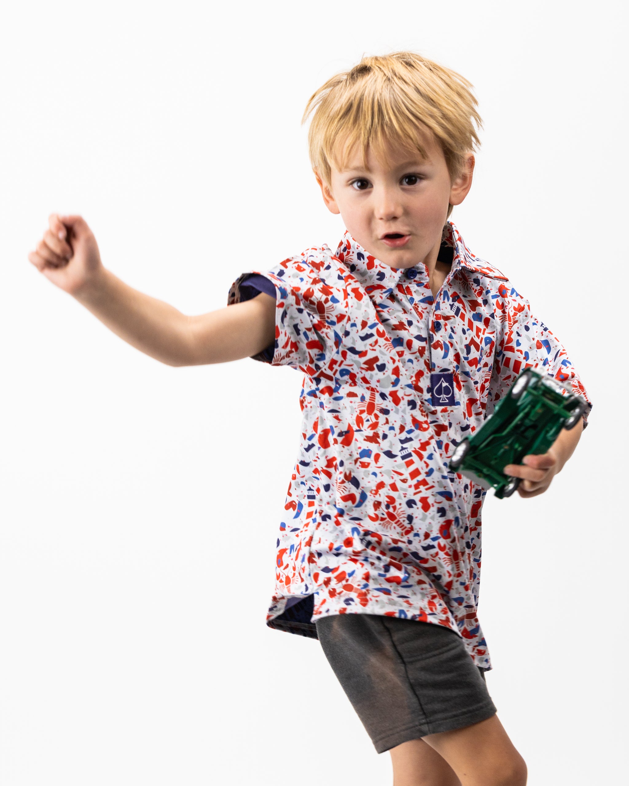 Youth Lobster Shatter polo shirt in vibrant colors, featuring a playful lobster design and a modern fit, displayed on a neutral background.