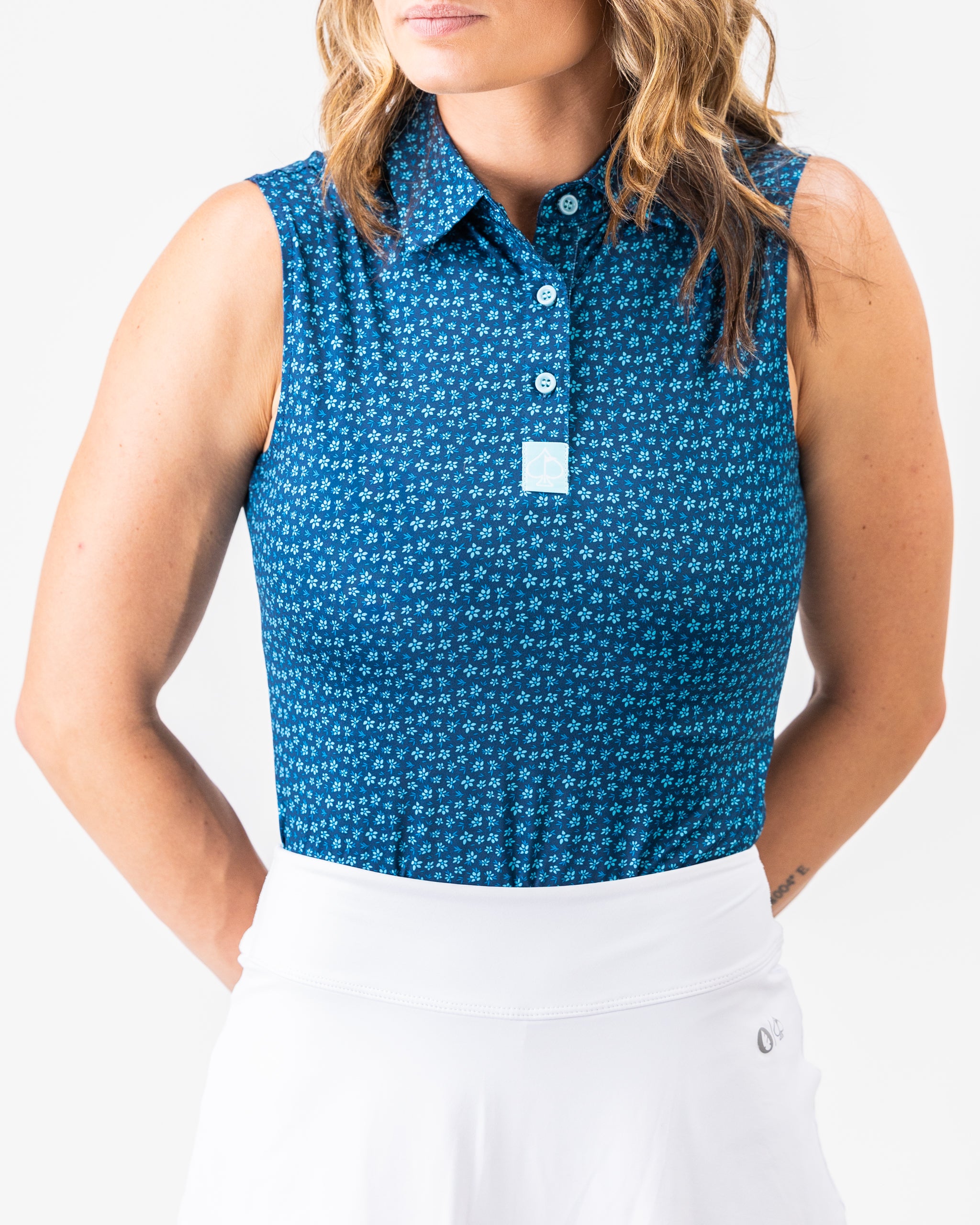 Women's blue micro floral polo shirt featuring a delicate pattern, perfect for casual wear.