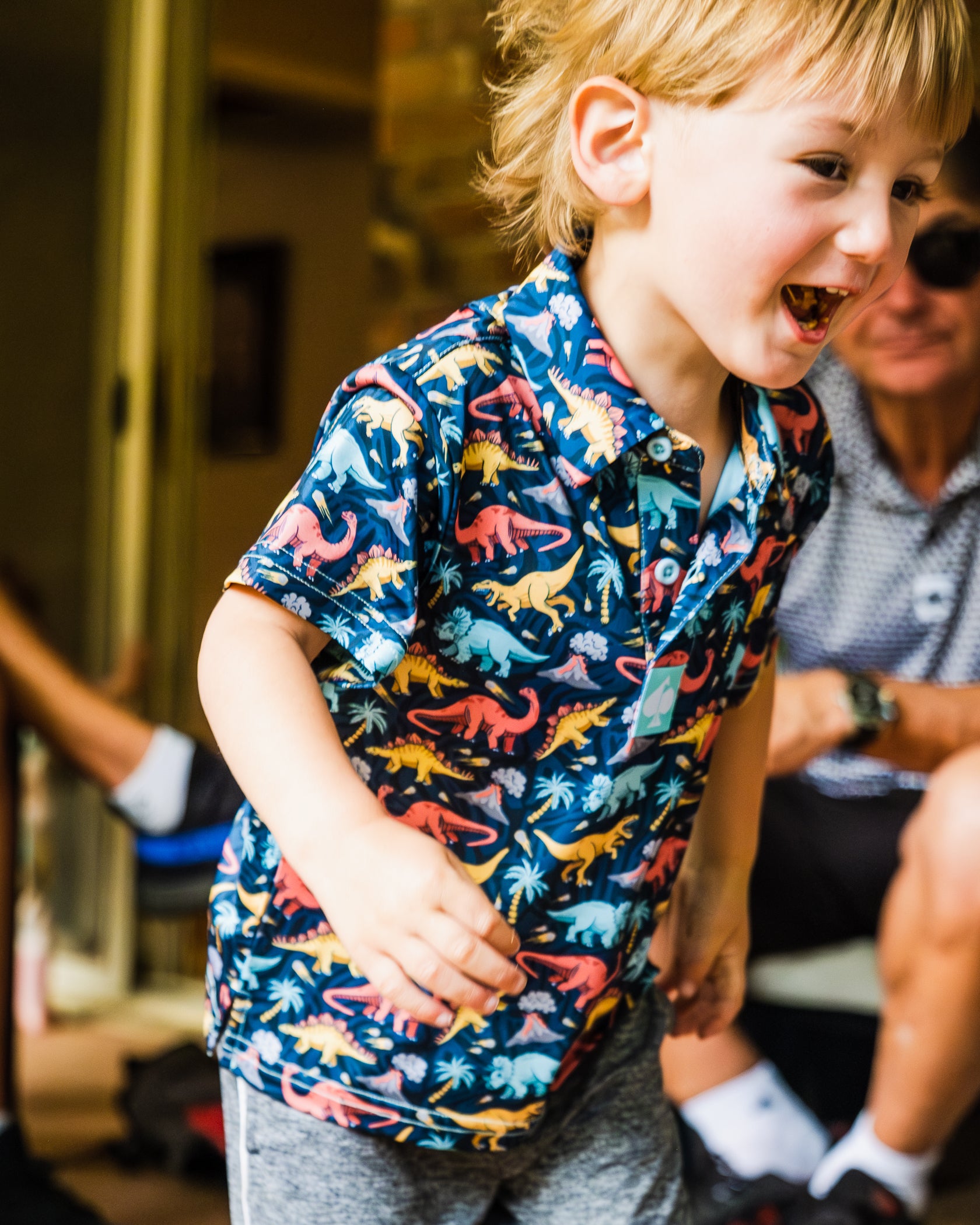 Youth Jurassic Polo featuring a vibrant dinosaur print, ideal for playful and adventurous styles.