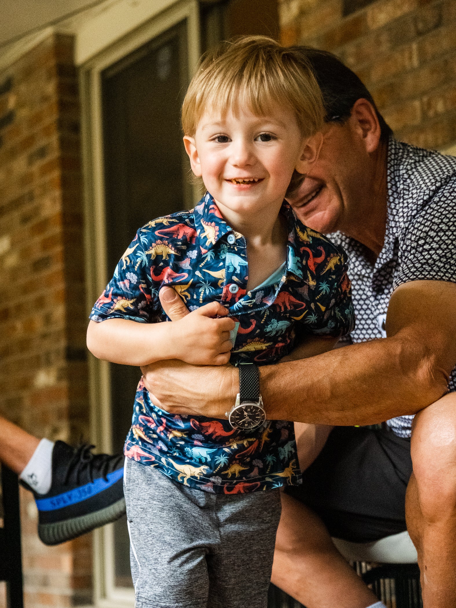 Youth Jurassic Polo featuring vibrant dinosaur prints, a classic collar, and a comfortable fit, ideal for young dinosaur enthusiasts.