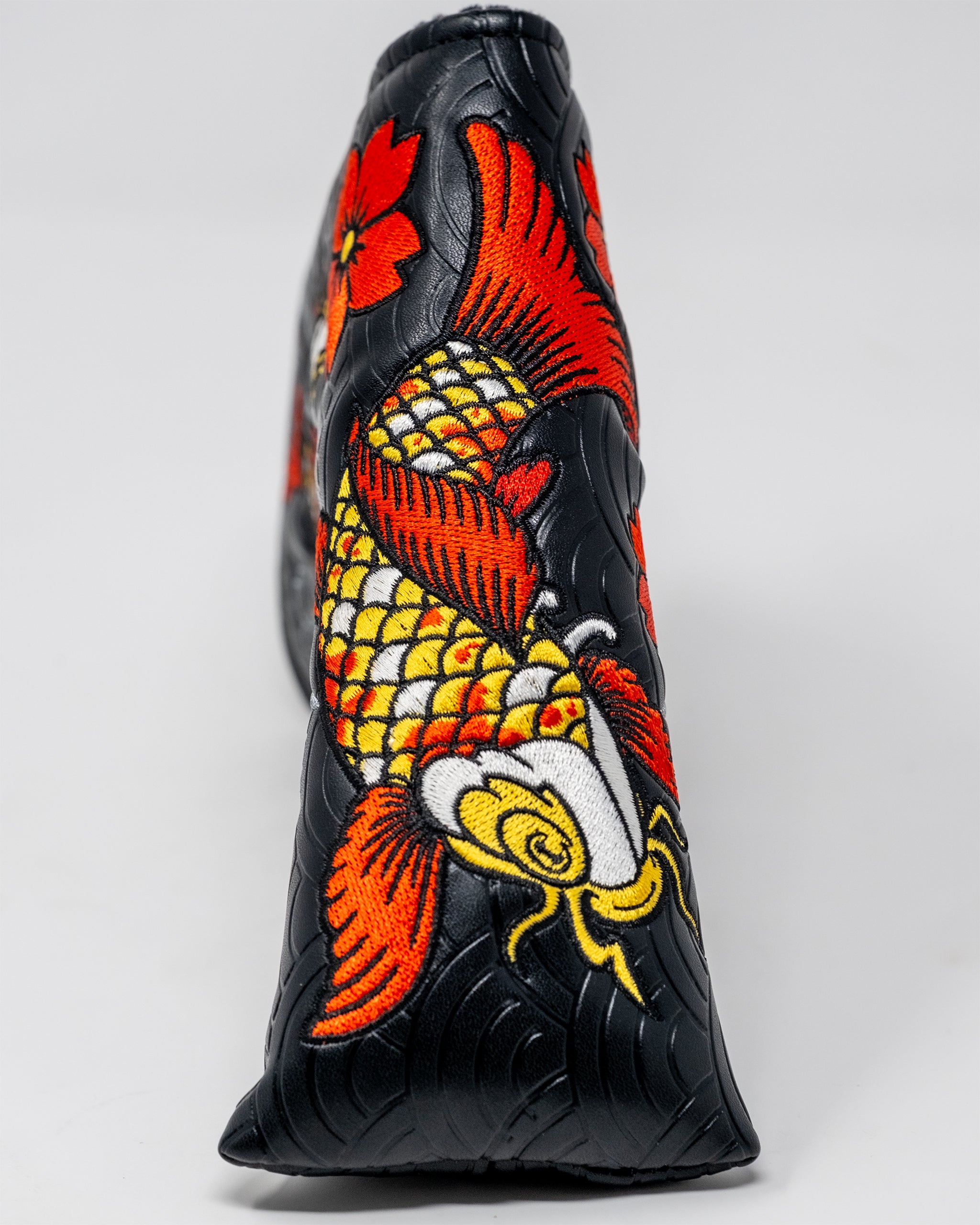 Koi Flow Blade Putter Cover featuring vibrant fire wave designs and a sleek fit for golf clubs.