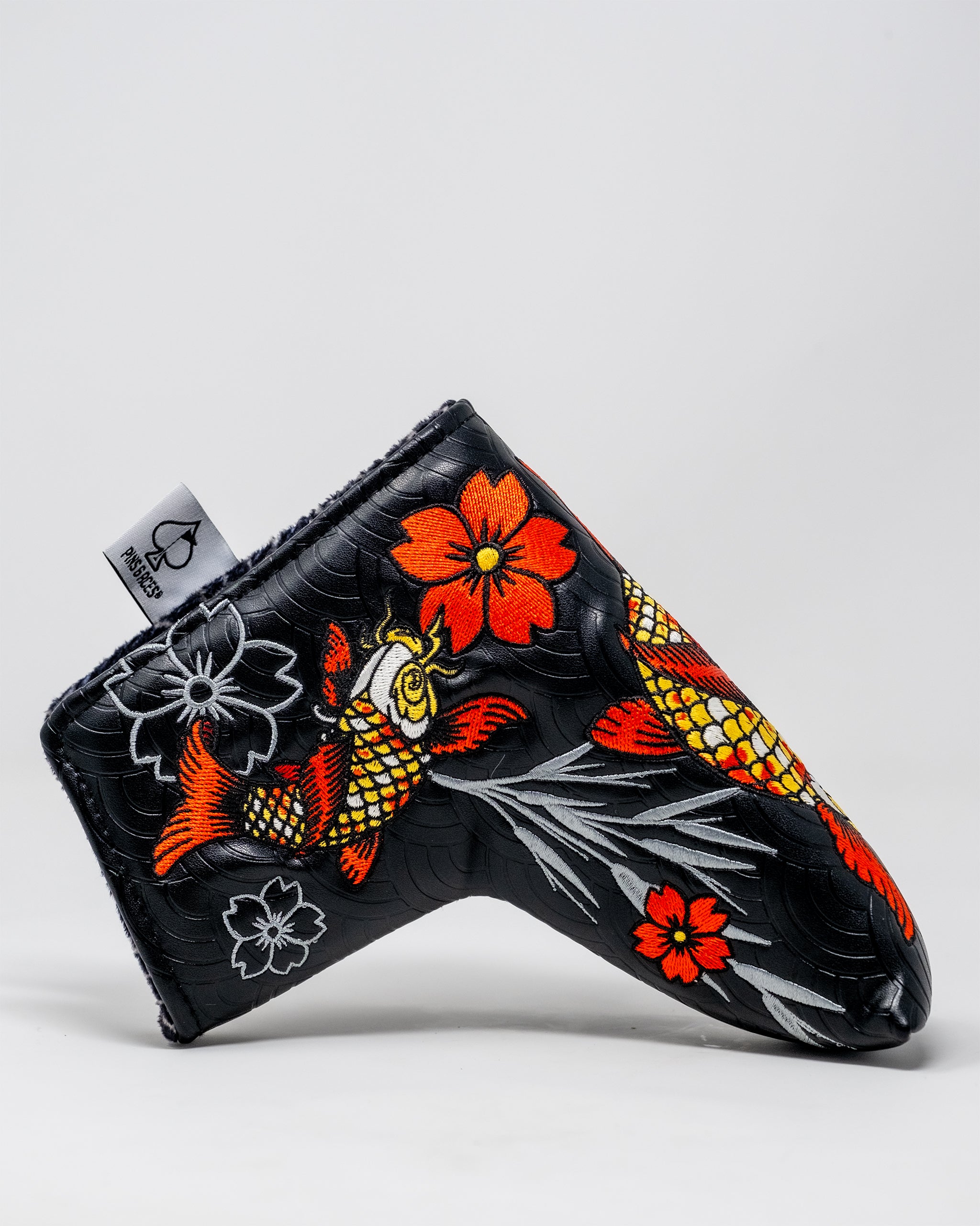 Koi Flow Blade Putter Cover featuring a vibrant fire wave design in shades of orange, red, and blue, tailored for standard blade putters.