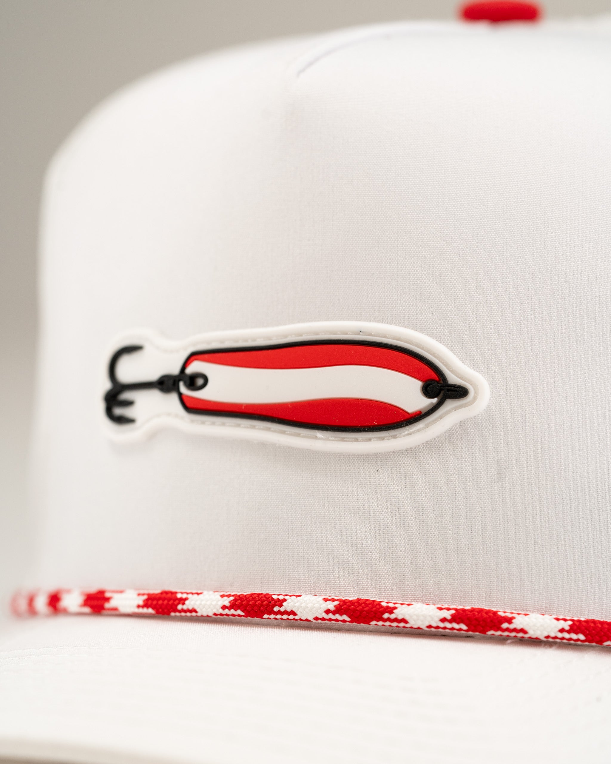 White perforated rope hat featuring a bold red and black Dare Devil Spoon design, perfect for stylish golfers.