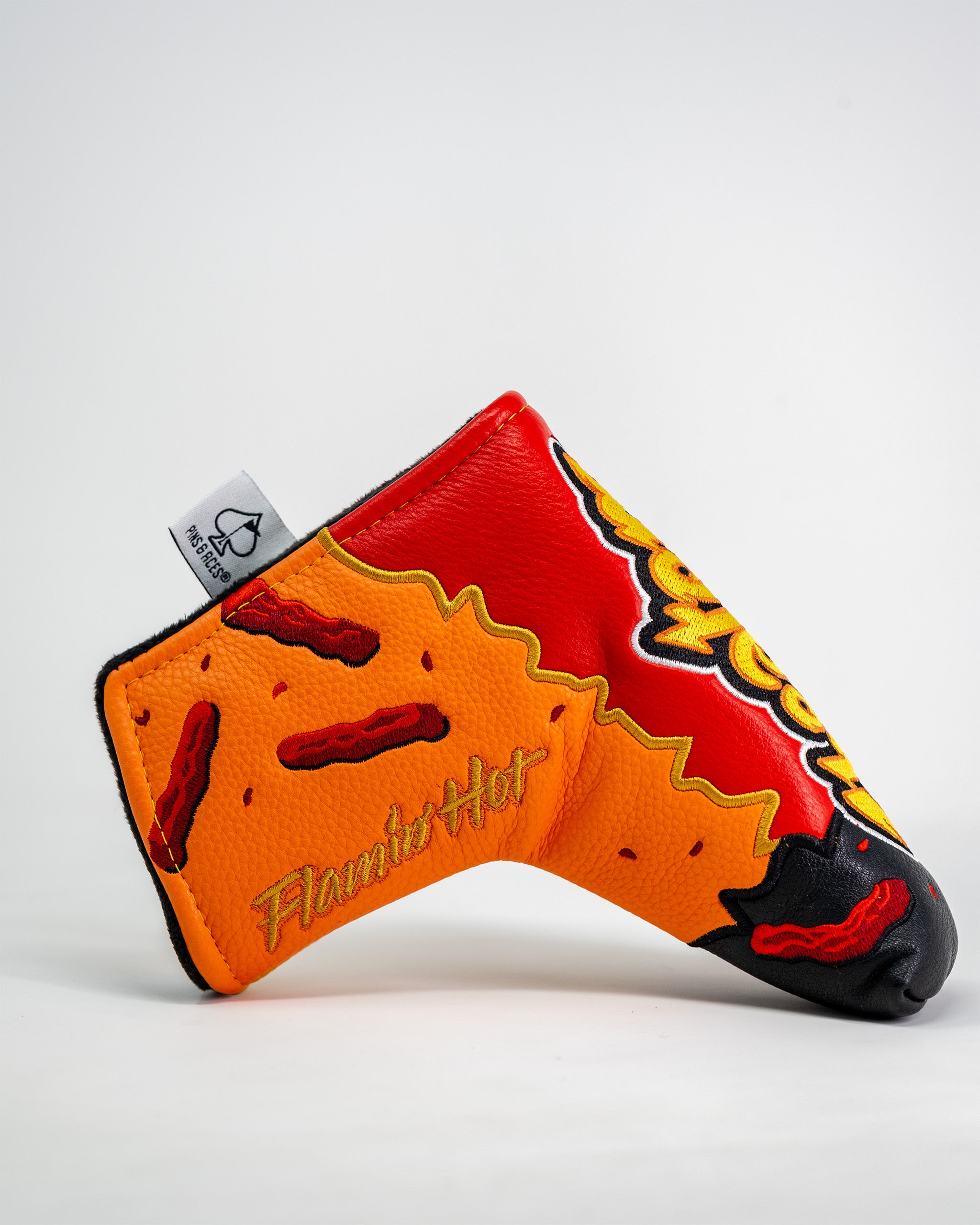 Flamin' Hot Cheaters Blade Putter Cover featuring fiery chili pepper design and embroidered Flamin' Hot logo.