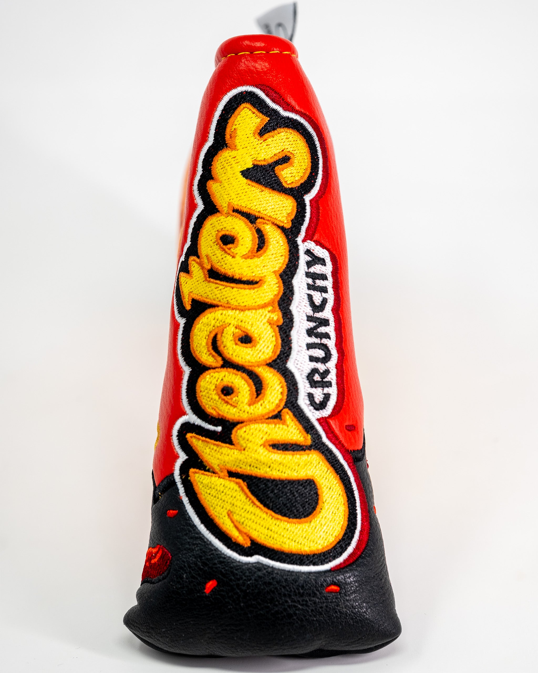 Golf blade putter cover featuring a red, black, and yellow embroidered design inspired by Flamin' Hot Cheetos.