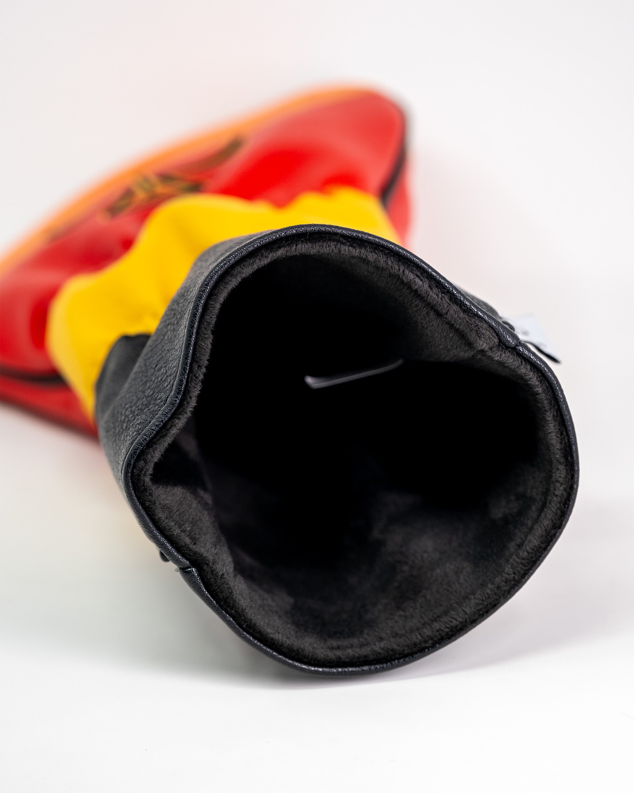 Close-up of a golf driver cover featuring a spicy Flamin' Hot Cheaters design with red, yellow, and black colors.