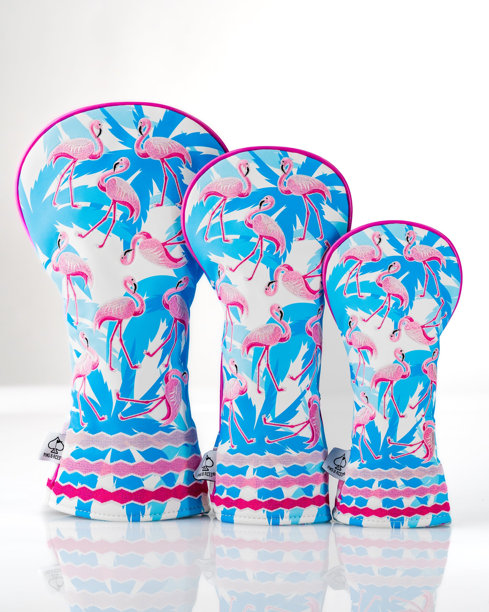 Flamingo Flock Headcover Set featuring vibrant flamingo designs in pink and blue, perfect for stylish golfers.