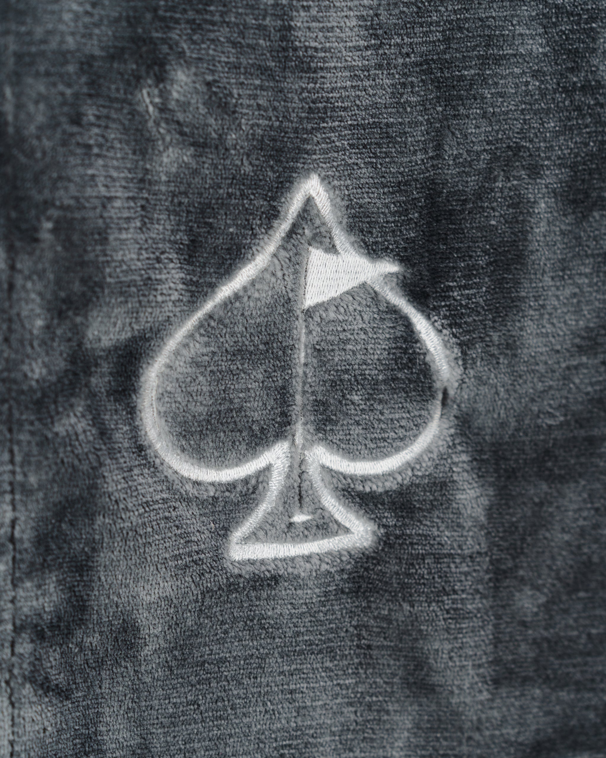 Dark gray Bogey Blanket made of soft fleece, neatly folded and placed on a wooden surface.