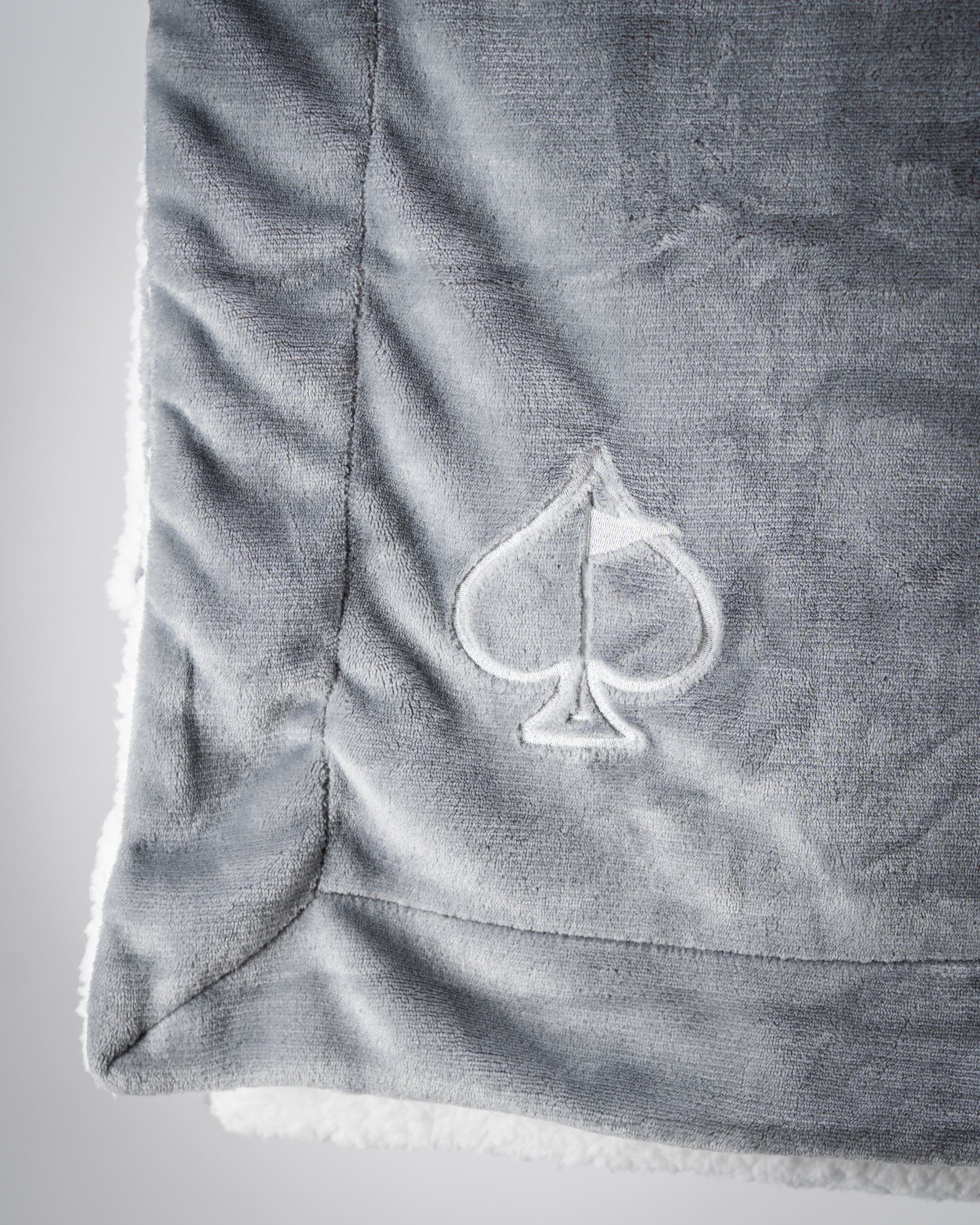 Light gray Bogey Blanket featuring a soft, plush texture, ideal for cozying up in colder weather.