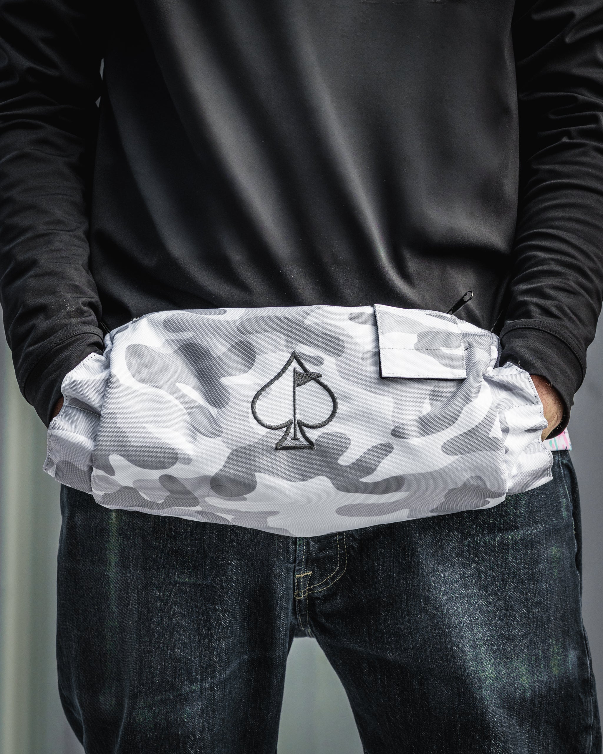 Stylish electric hand warmer in gray camouflage with a spade logo, designed for golfers to stay warm on the course.