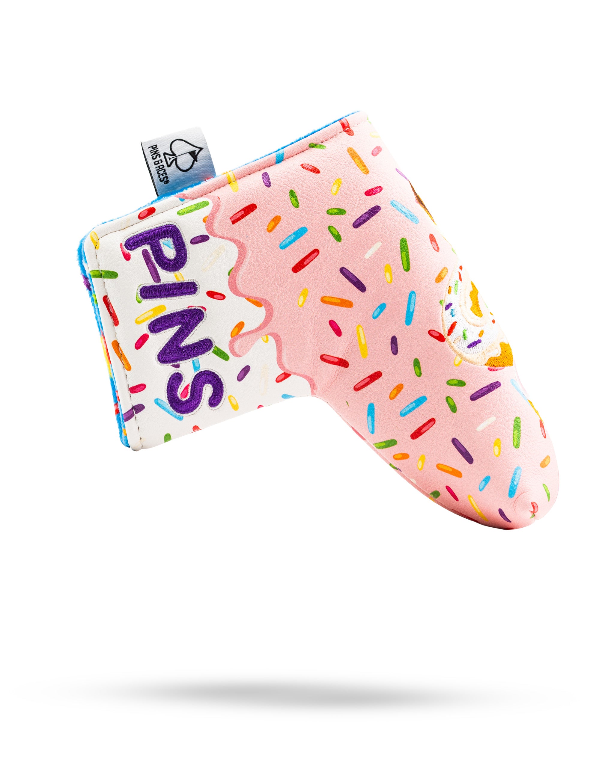 Colorful blade putter cover featuring a pink donut design with sprinkles and the word "PINS" prominently displayed.