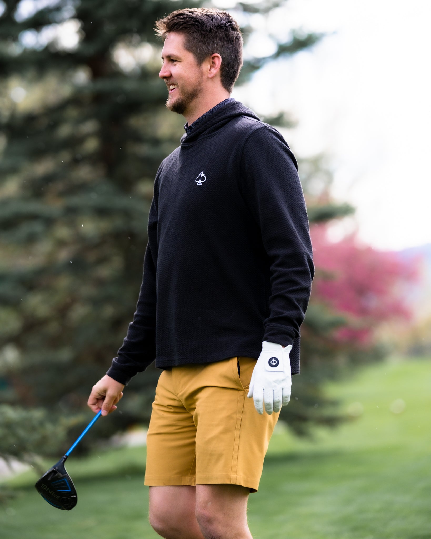 Performance shorts in a sandy beige color, ideal for golfing and outdoor activities.