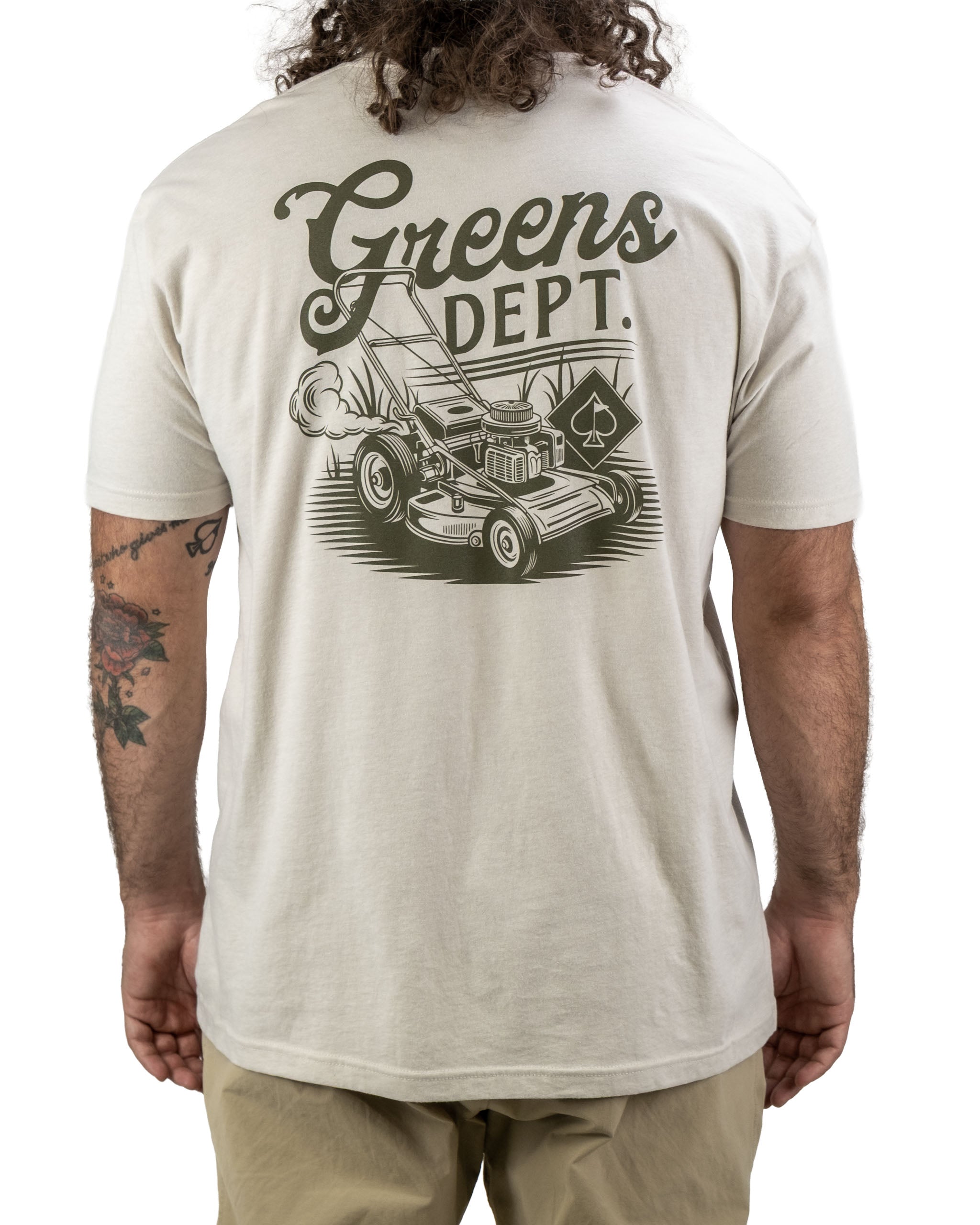 Men's beige tee shirt featuring a vintage lawnmower graphic and "Greens Dept." text on the back.