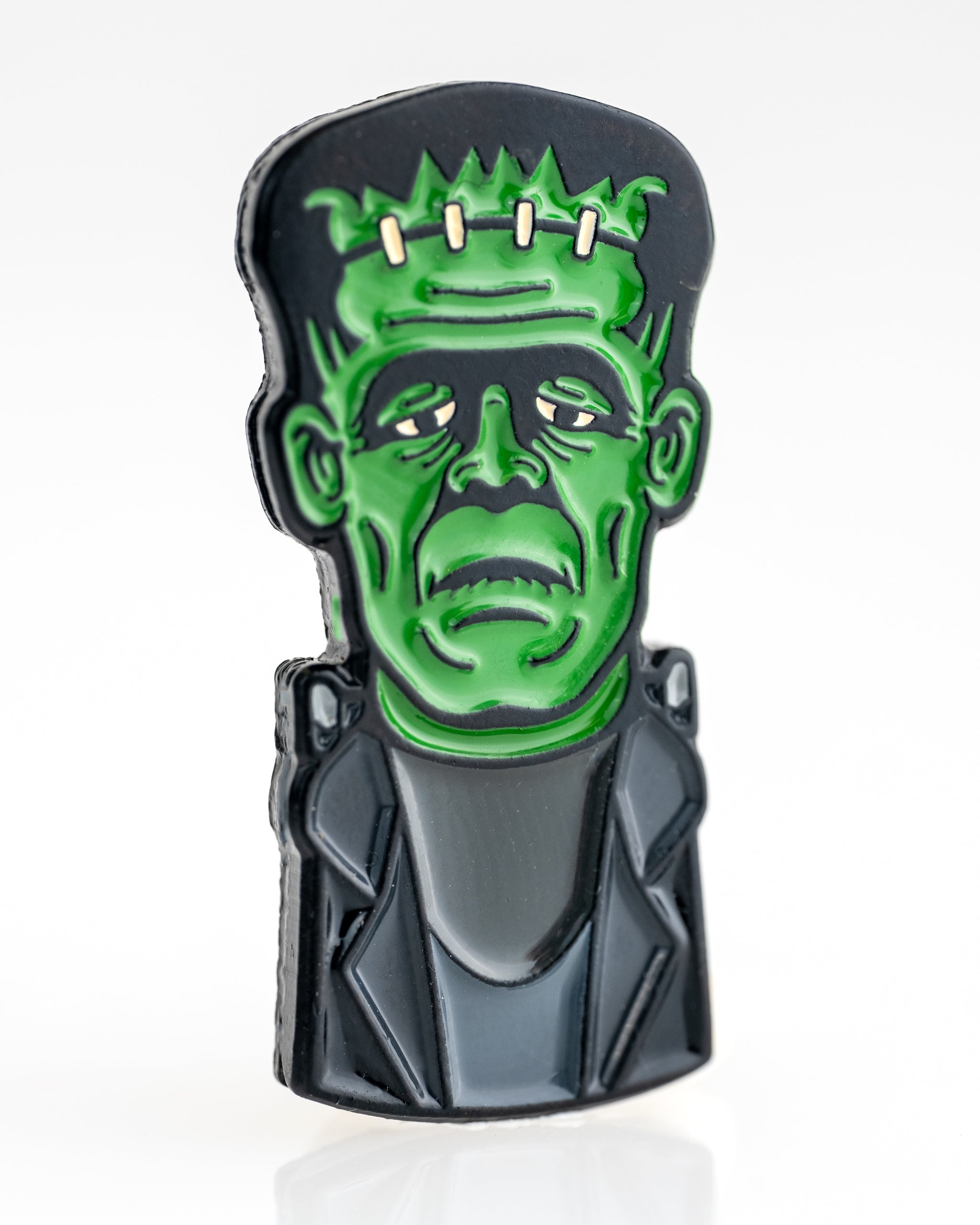 Frankenstein-themed ball marker for golf, featuring a vibrant green design with monster facial features on a circular disc.