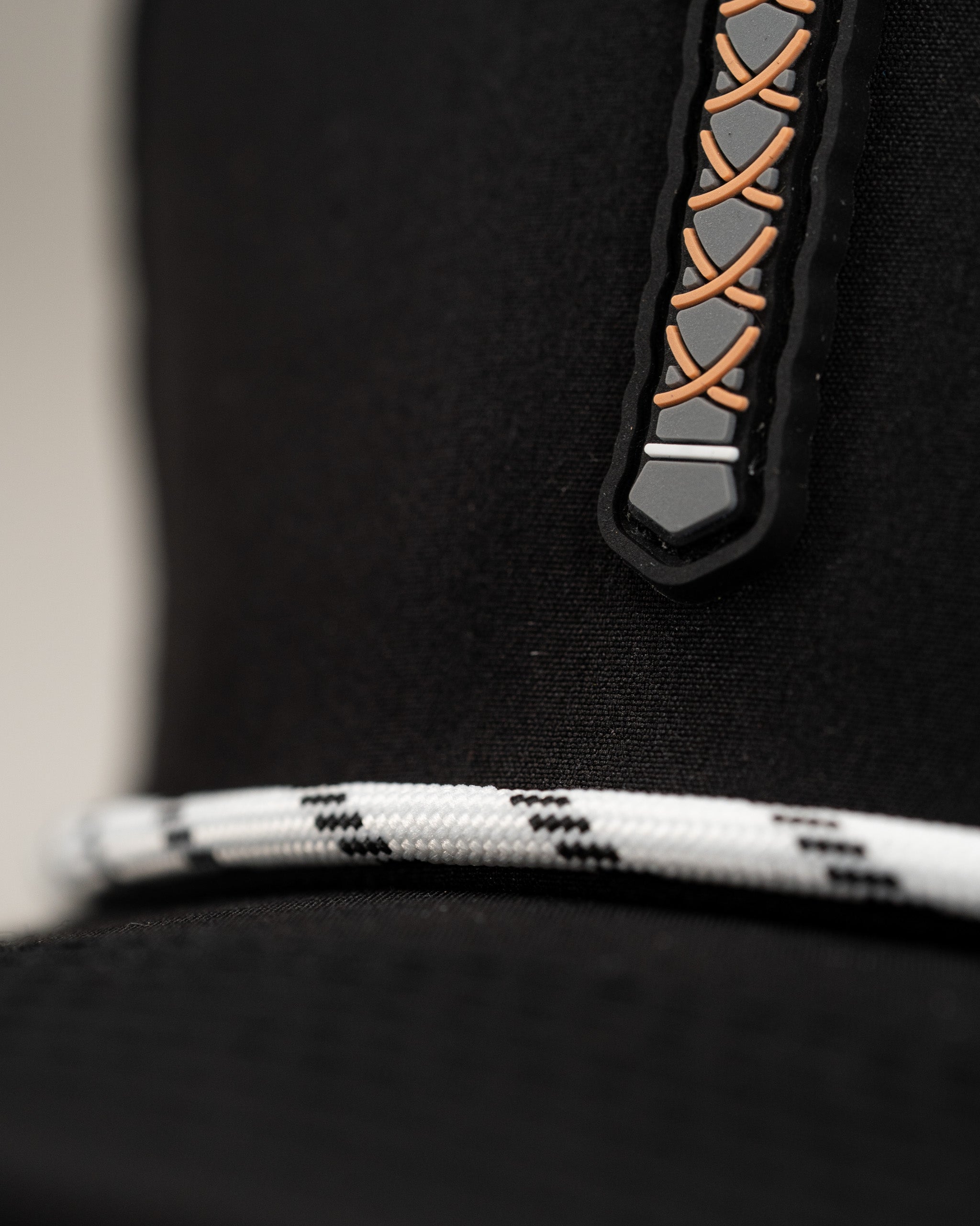 Close-up of the Thor's Hammer Black perforated rope hat featuring a unique lace design and a stylish rope band.