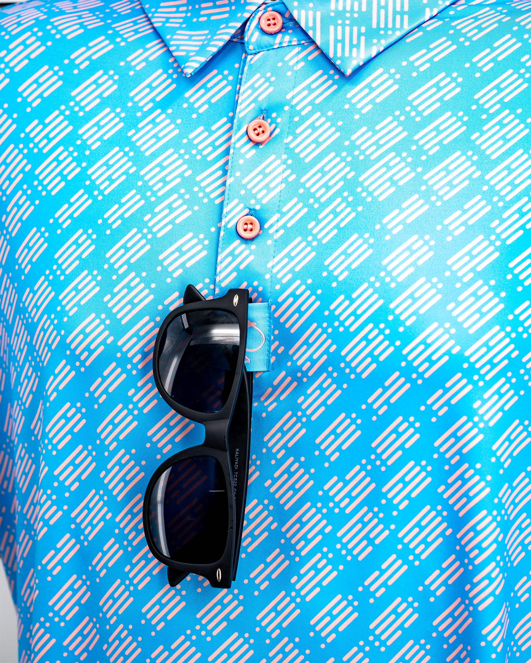 Skyline Dash Blue polo shirt hanging on a display, featuring a sleek design and vibrant blue color.