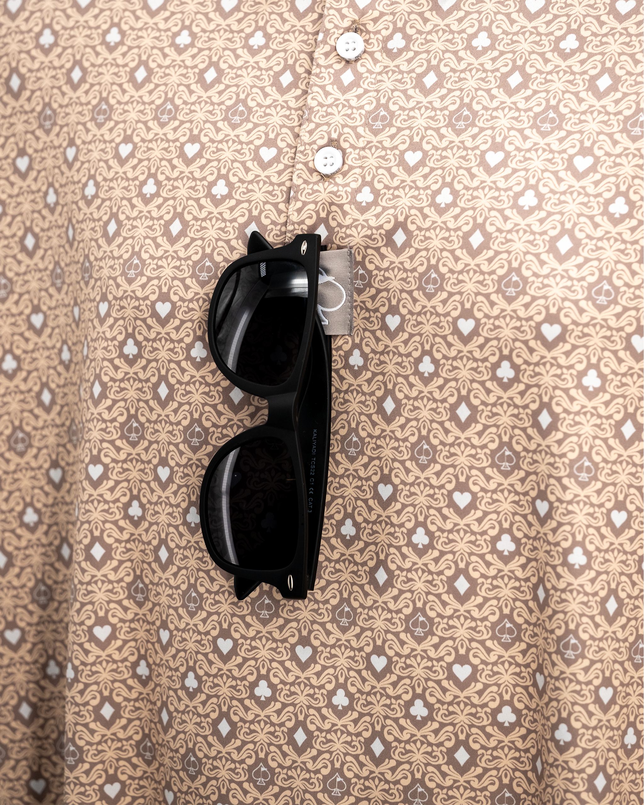 Big Blind Sand polo shirt displayed on a hanger, featuring a modern design and soft fabric texture.