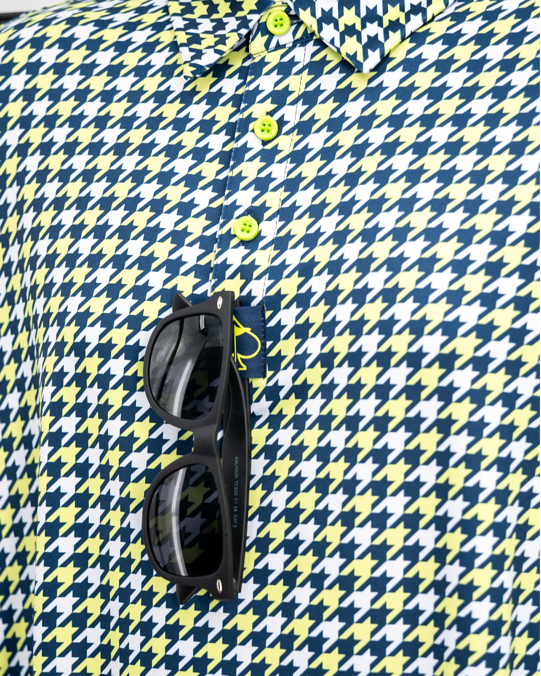 Houndstooth pattern polo shirt in lime green, showcasing a stylish design with a modern fit.