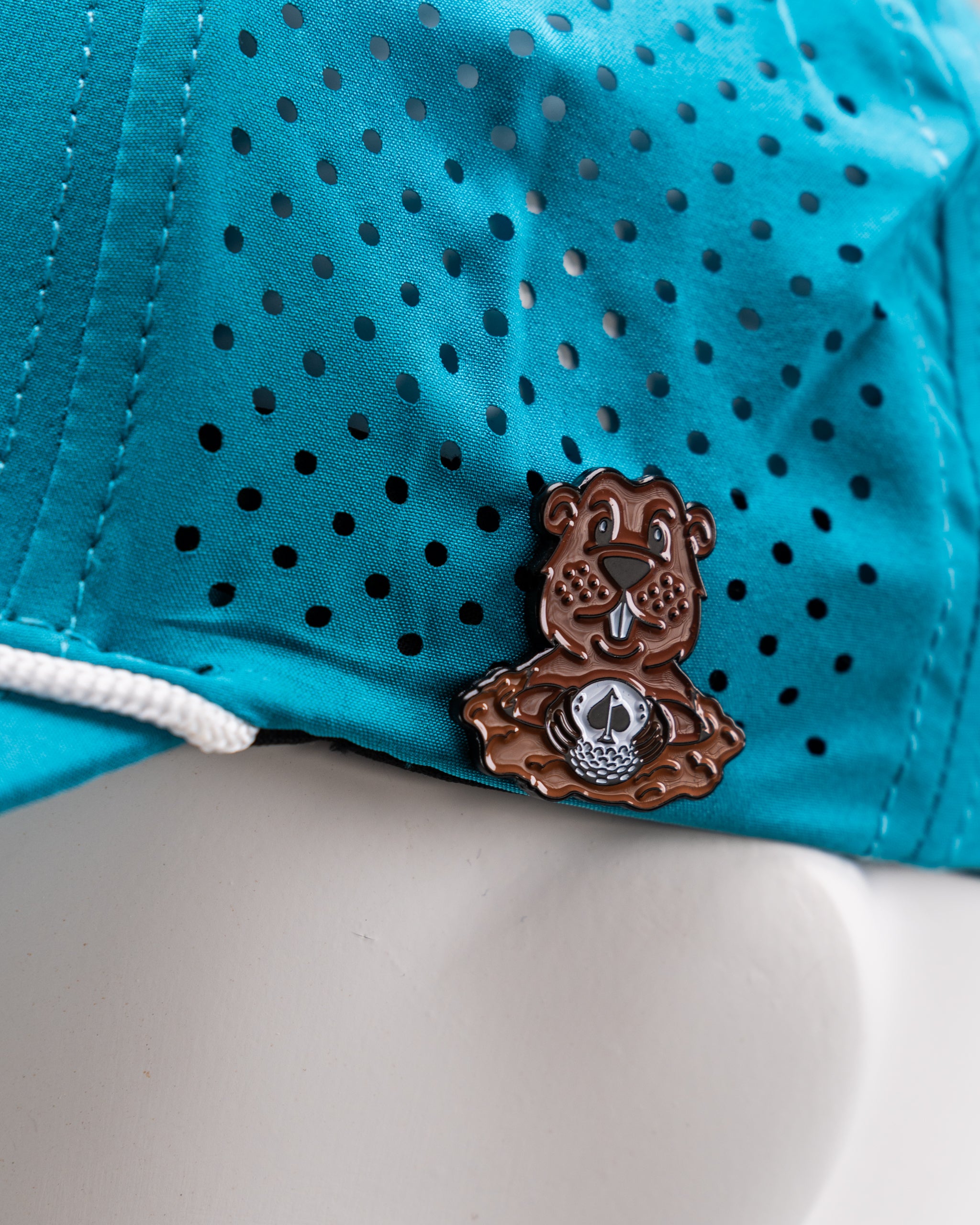Perforated baby blue rope hat featuring a Beaver Liquor logo patch.