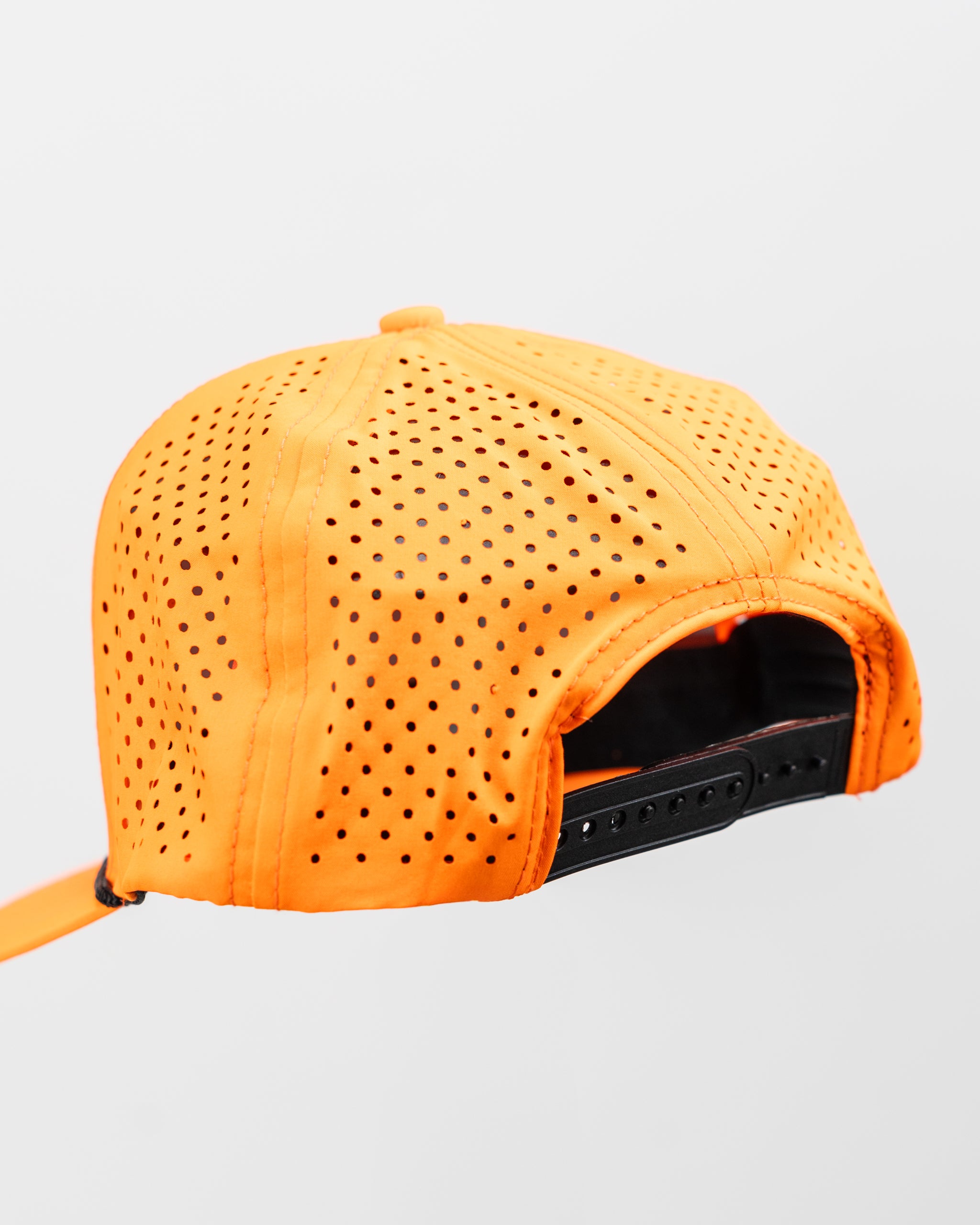 Perforated highlighter orange rope hat from Parlay, featuring a stylish design and snapback closure.