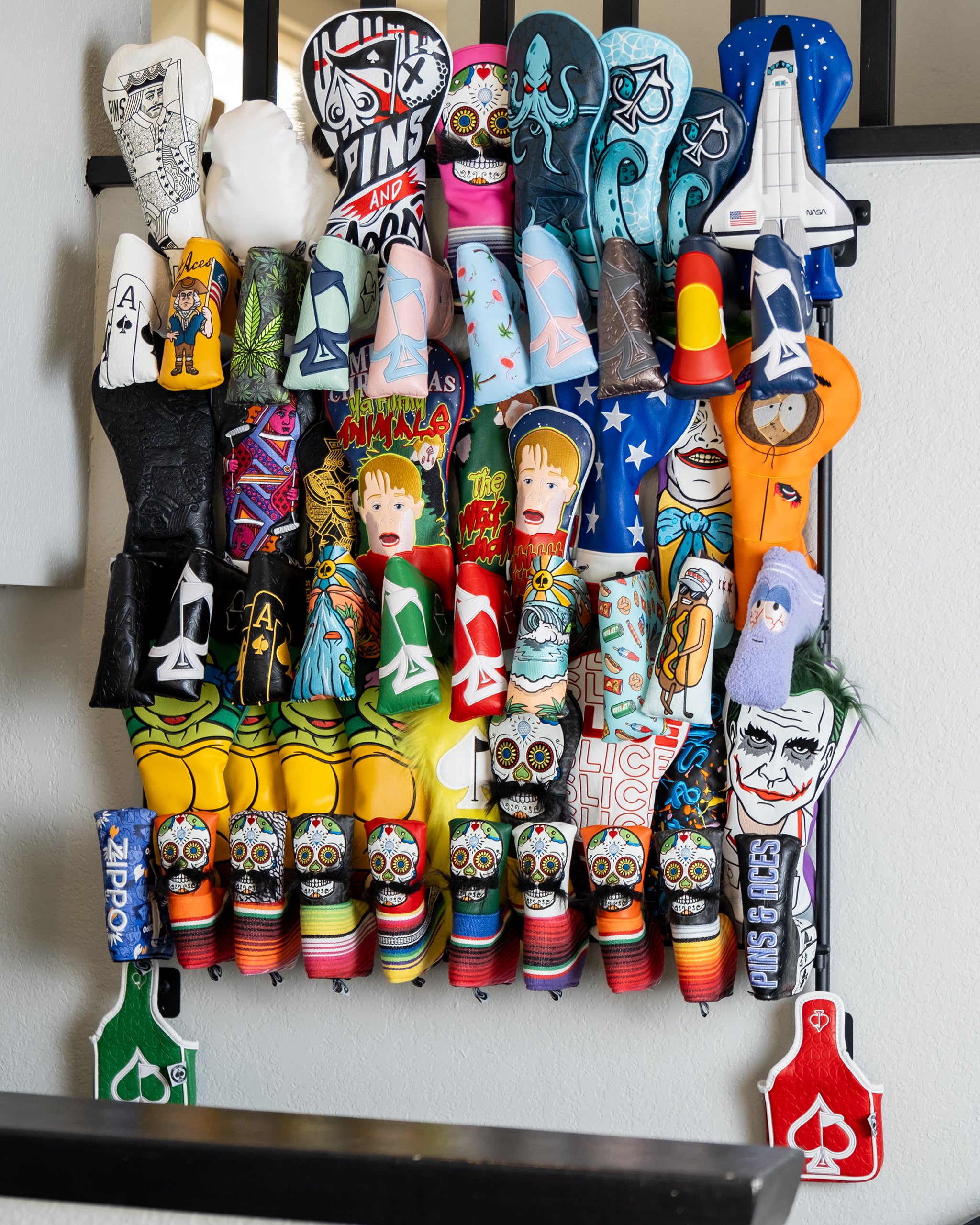 Headcover rack displaying organized golf headcovers in a sleek design, showcasing various colors and styles.