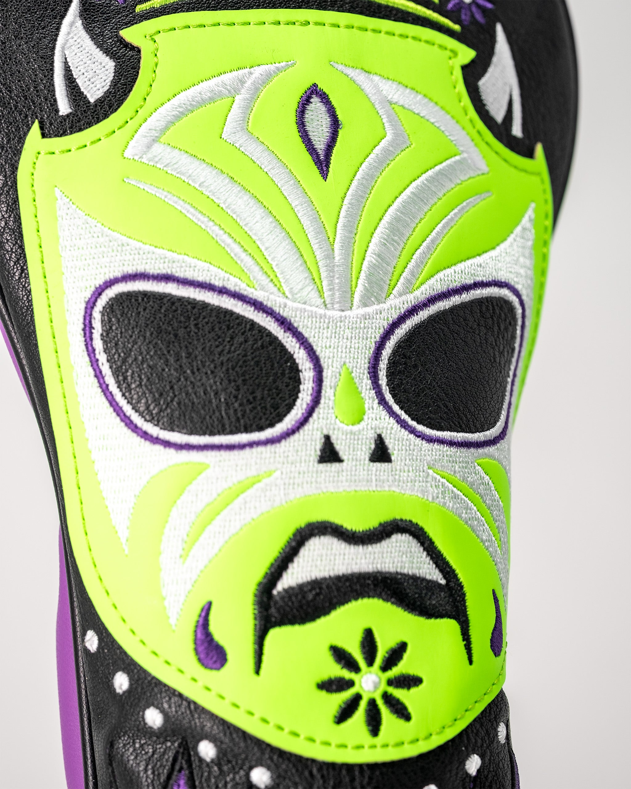 Lucha Libre mask-themed fairway golf club cover with vibrant yellow, black, white, and purple embroidery resembling a skull.