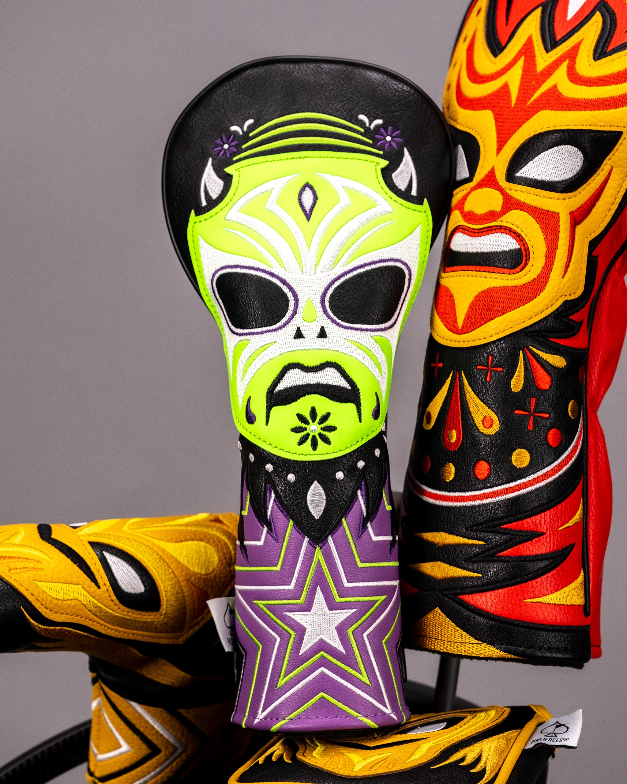 Colorful lucha libre mask-themed golf club fairway cover featuring a vibrant skeleton design with neon green, purple, and black accents.
