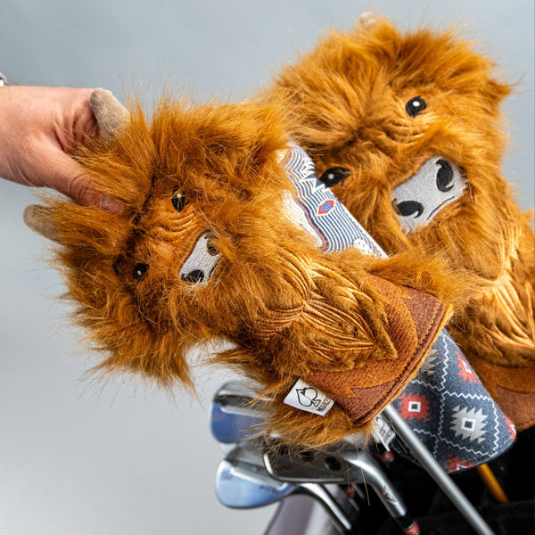 Bright orange lion headcover with faux fur, detailed face, and patterned fabric, designed for bold, unique golf style.