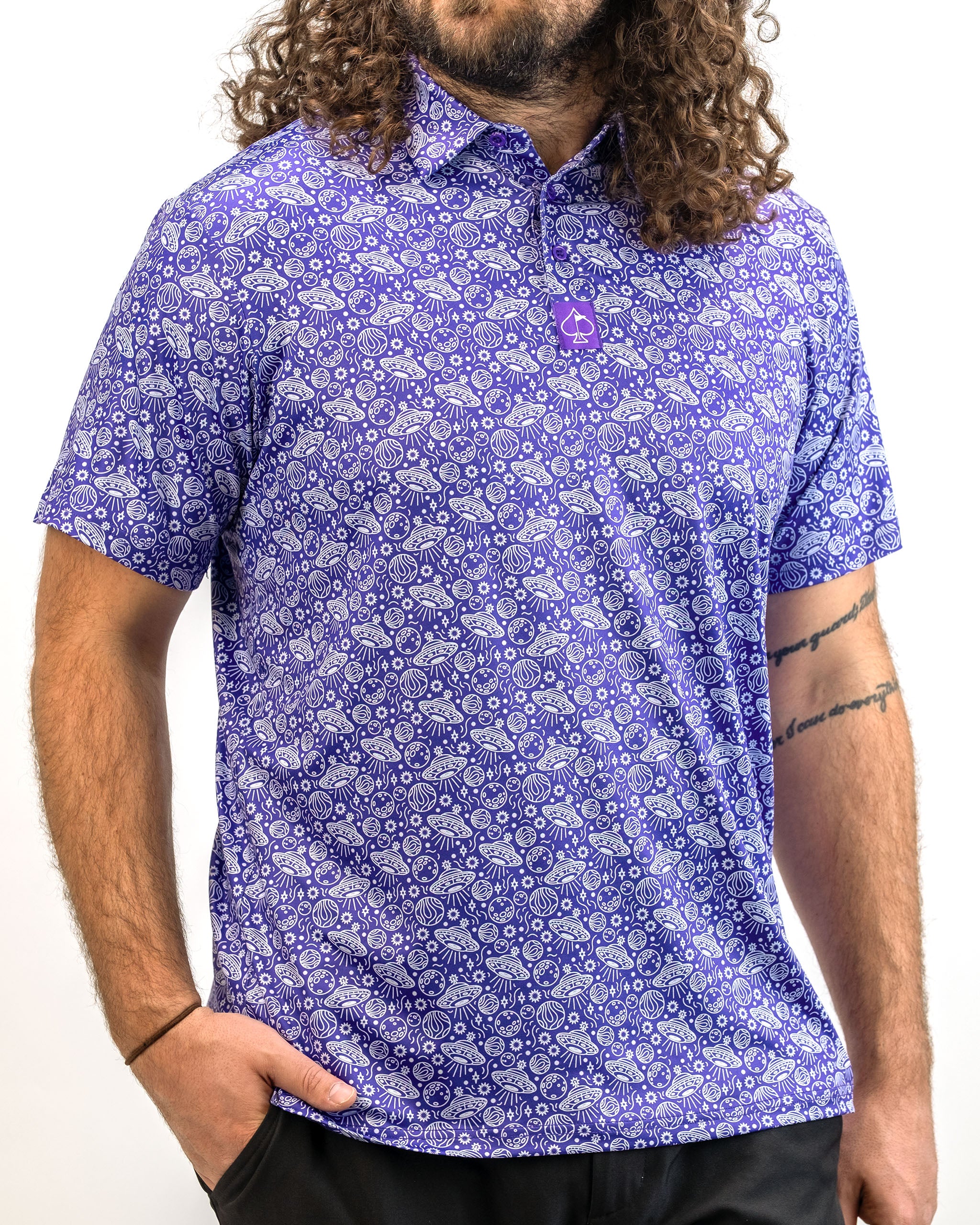 Men's HEYDUDE Indigolactic polo shirt displayed on a model, featuring a modern design in a deep blue color with subtle texture.