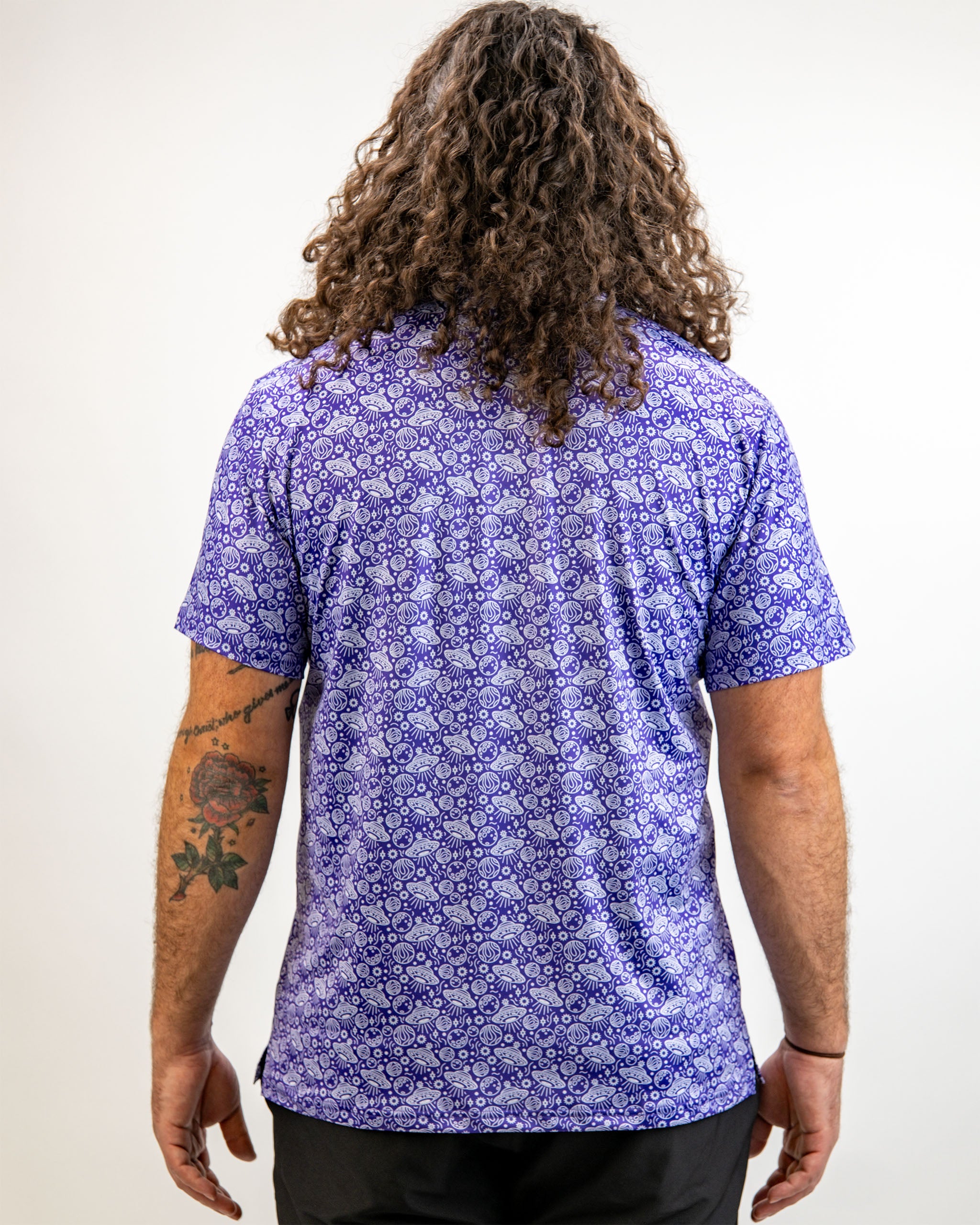 Men's HEYDUDE Indigolactic polo shirt displayed on a model, featuring a vibrant blue color and relaxed fit.