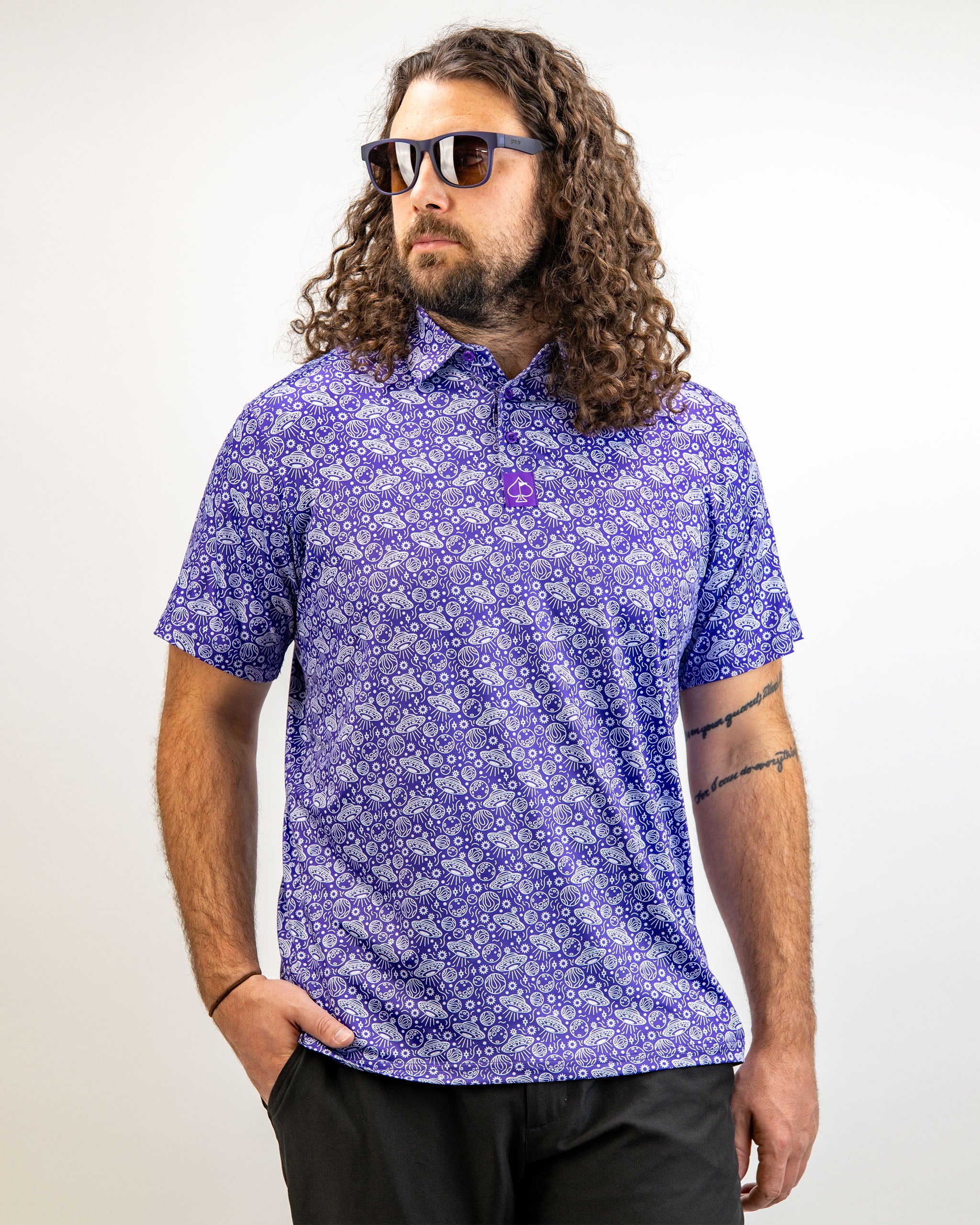 Men's HEYDUDE Indigolactic polo shirt worn by a model, featuring a vibrant indigo color and stylish design.