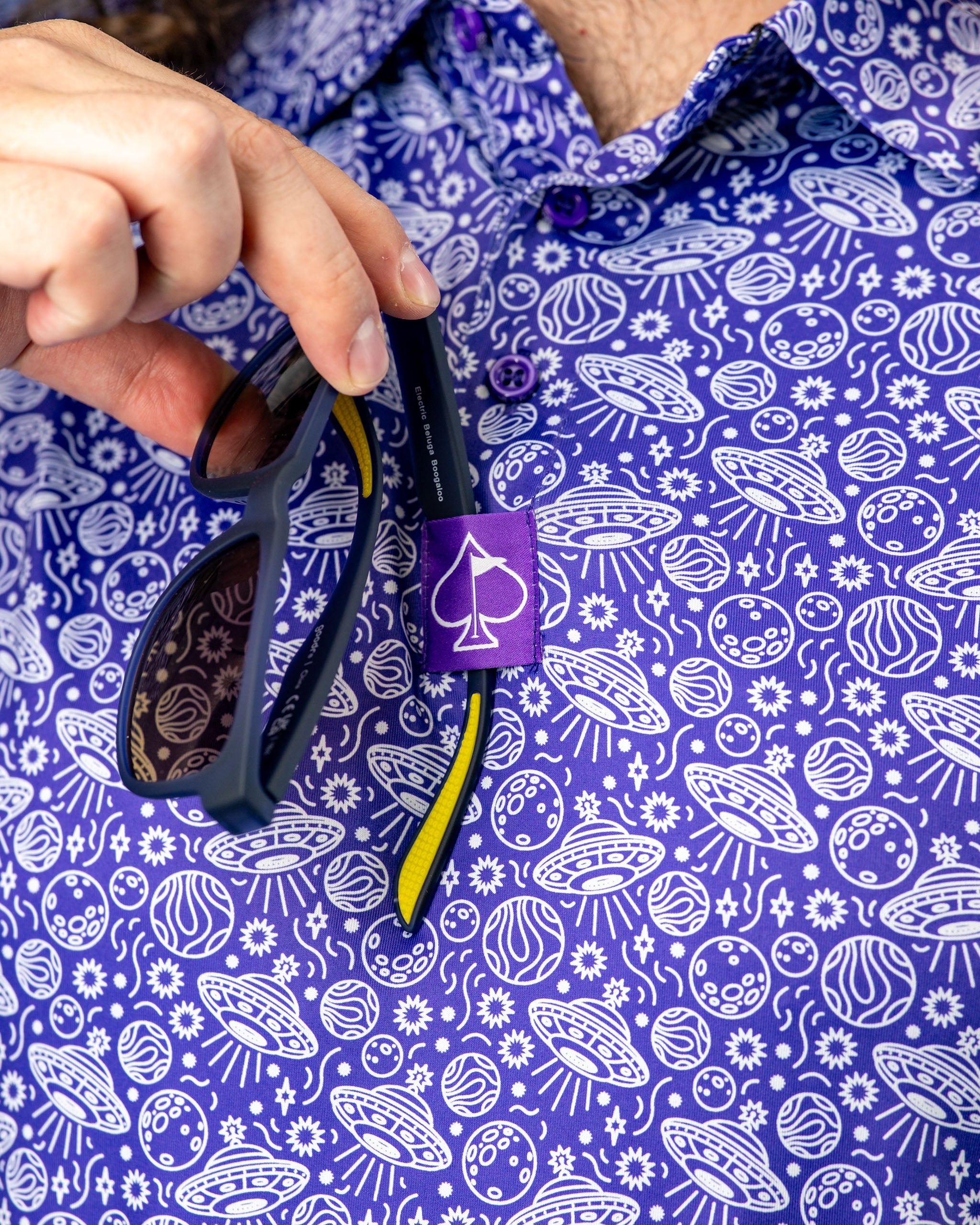 Men's HEYDUDE Indigolactic polo shirt displayed on a model, featuring a vibrant blue color and casual design.